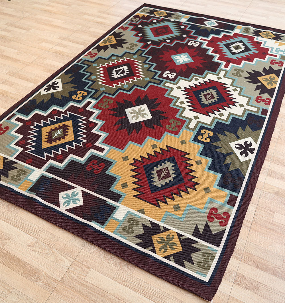 The RAMSHA HOME Tribal Digital Printed Rug (DD-045) is a colorful geometric area rug with vibrant red, yellow, green, blue, and white diamond and zigzag patterns in a southwestern style, perfect for light wood floors.