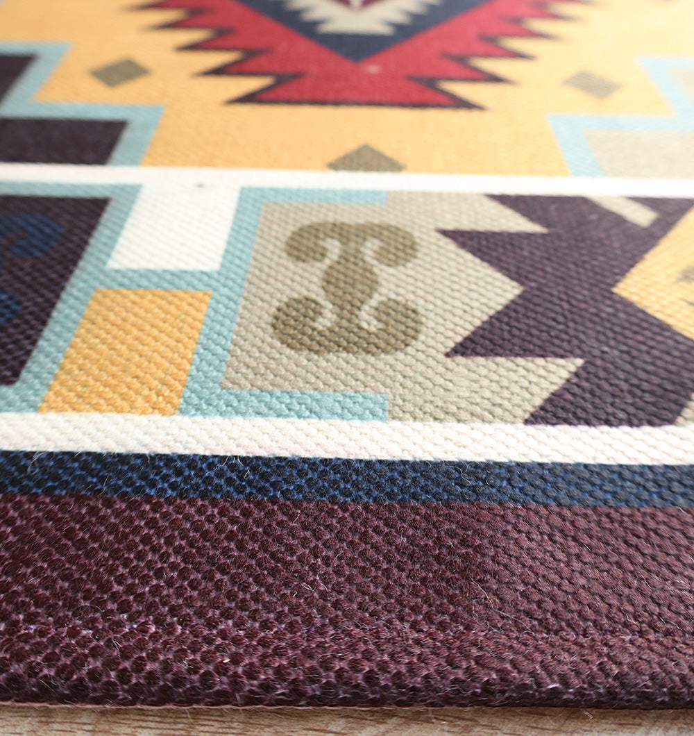 Close-up of RAMSHA HOME's Tribal Digital Printed Rug (DD-045), a colorful geometric area rug for living rooms, showcasing vibrant yellow, maroon, blue, and green tones with detailed textures and sharp design elements.