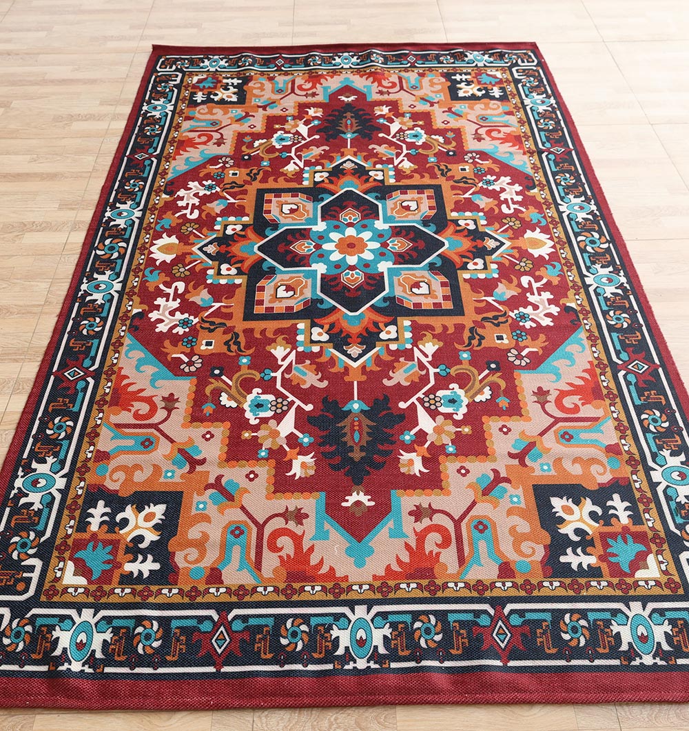 The RAMSHA HOME Bohemian Floral Medallion Printed Area Rug DD-050 features a vibrant geometric medallion design with red, blue, orange, and white tones, intricate borders, and is shown on a light wooden floor.