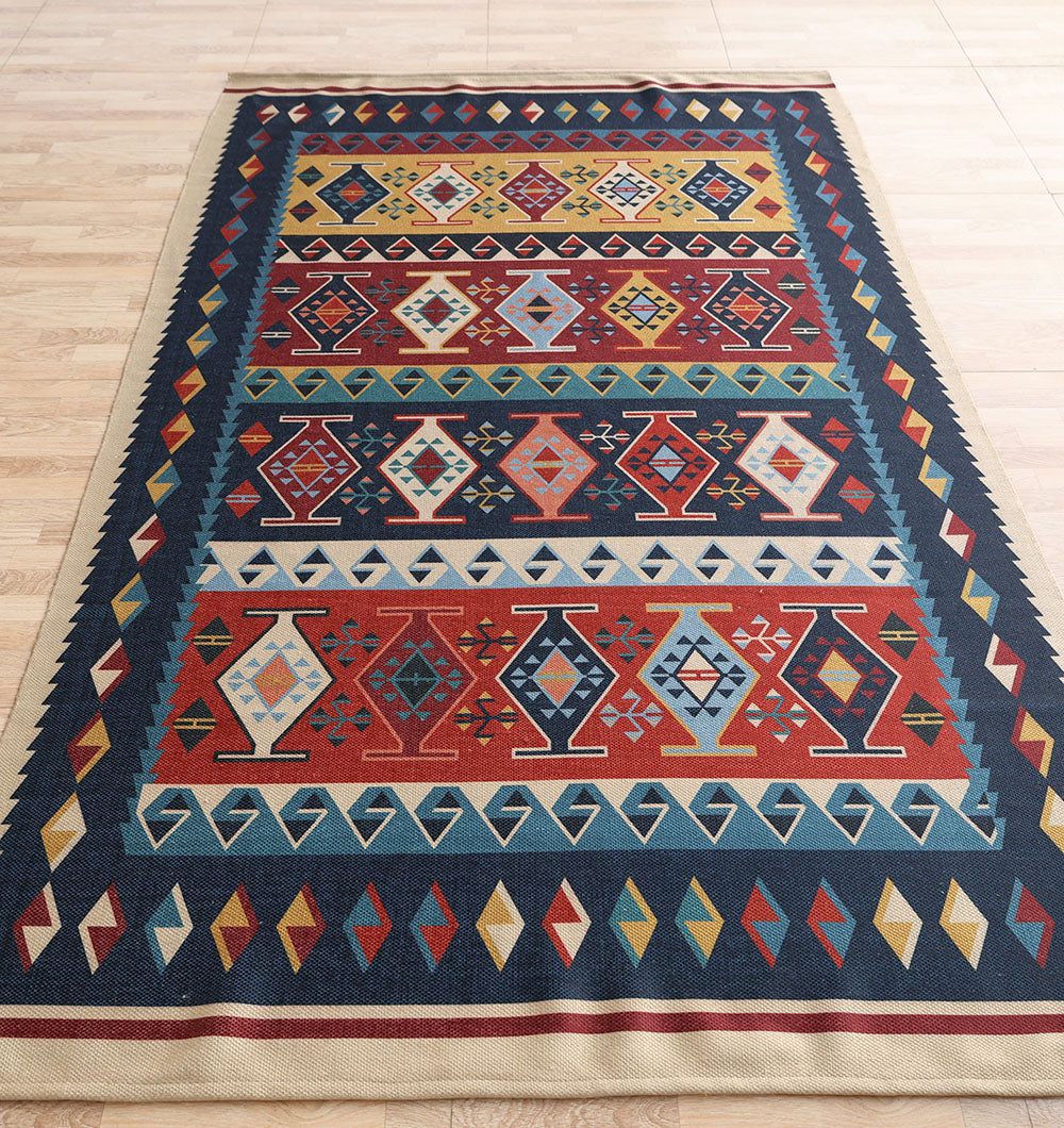 The RAMSHA HOME Classic Heritage 145x240 cm Digital Printed Area Rug DD-051 features colorful geometric patterns in red, blue, yellow, green, and cream tones and is displayed on a light wooden floor.