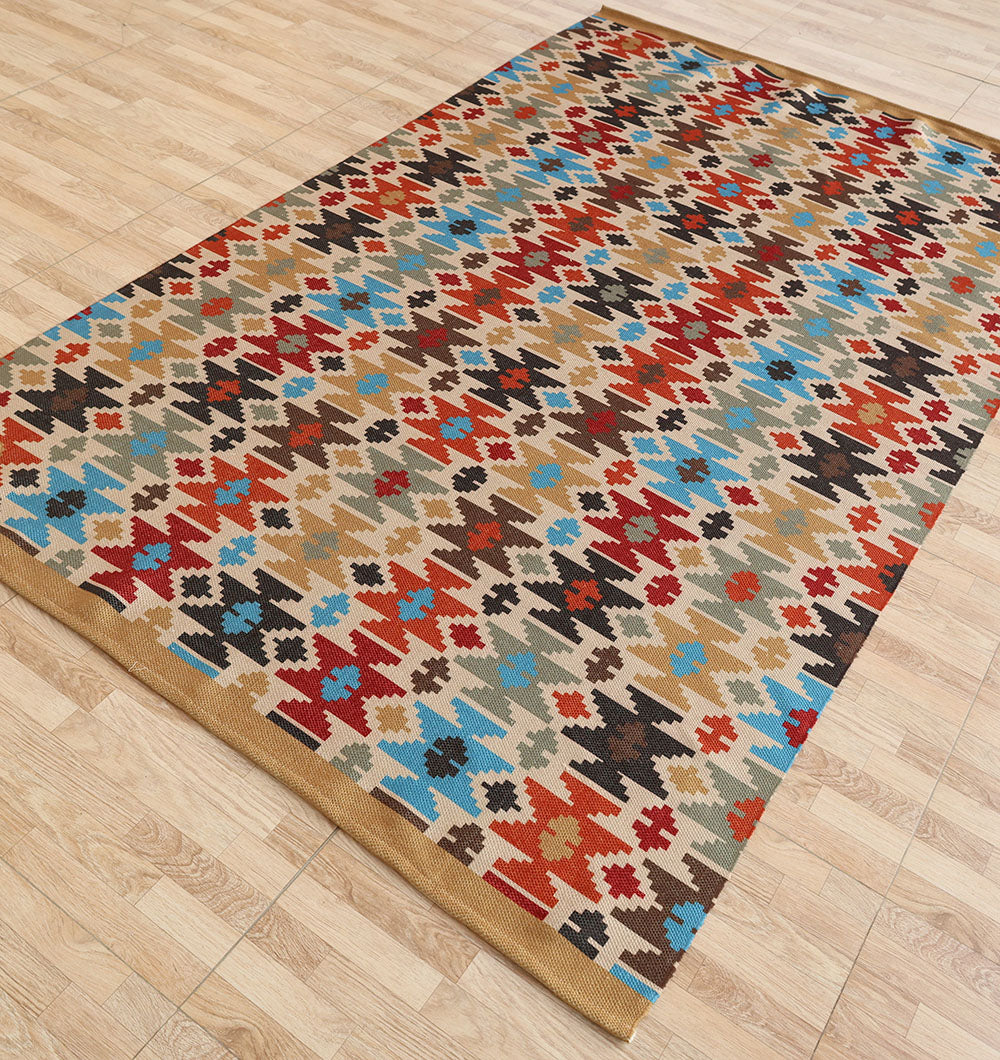 The RAMSHA HOME Tribal Mosaic Digital Printed Rug 145x240 cm DD-052, featuring a geometric, multicolored pattern in red, blue, black, and beige, is displayed on a light wood floor.