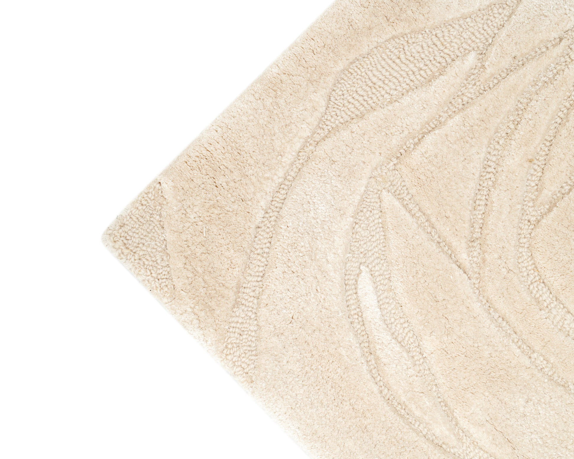 Close-up of the corner of the Home Decor Handmade Area Rug - HTWV-156 by RAMSHA HOME in beige, featuring a subtle embossed linear leaf or floral pattern that highlights its beautifully carved texture.