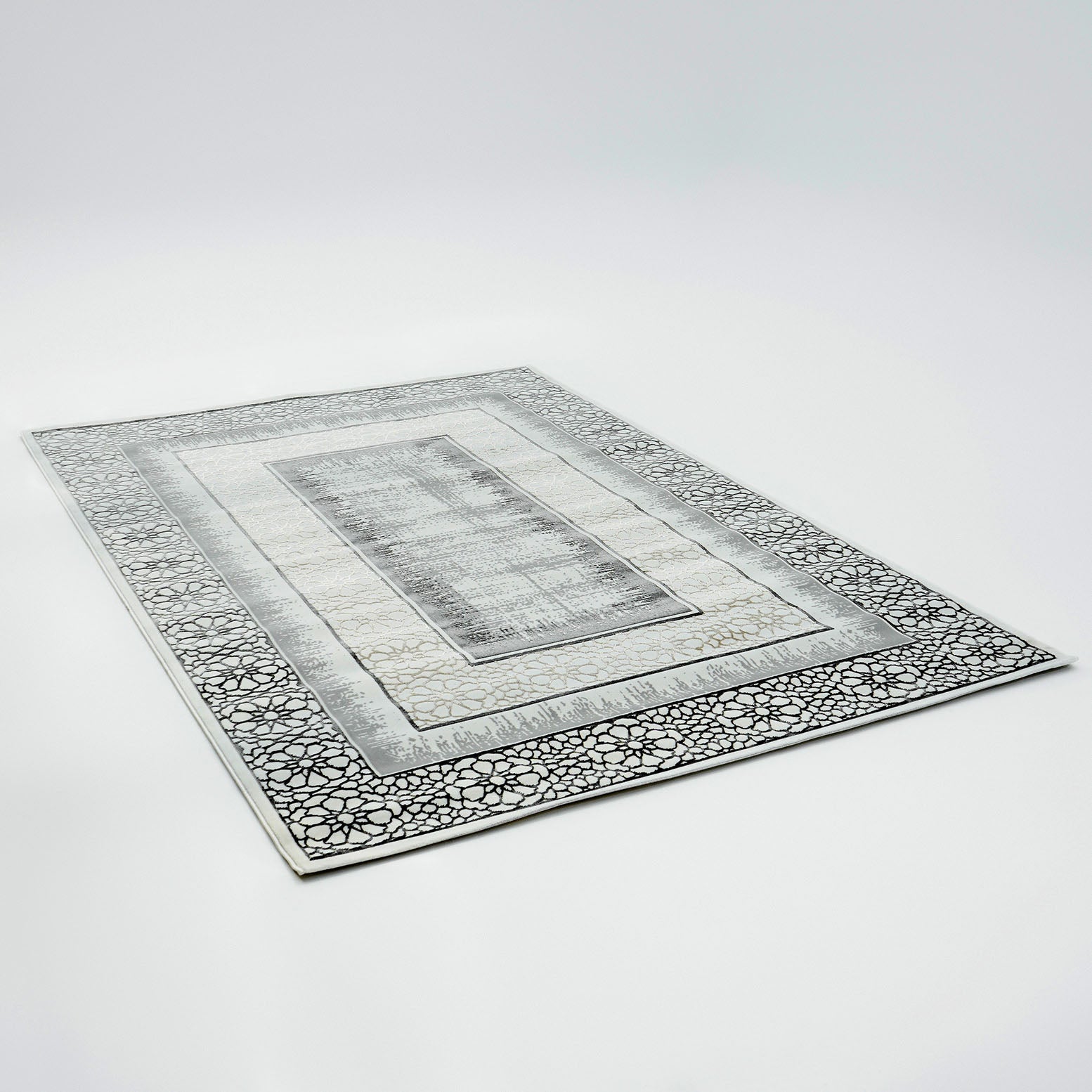 The RAMSHA HOME Grey Color ND81A BARCELONA Decor Area Rug features a rectangular black and ivory design with intricate geometric and floral borders in gray, white, and black, shown on a plain white background.