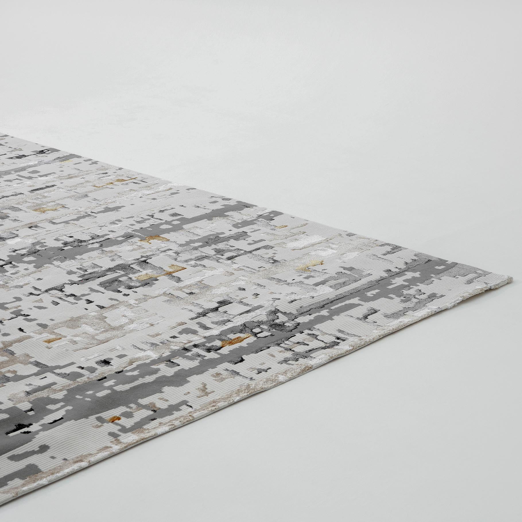 A close-up of the RAMSHA HOME Geometry Pattern Cream Colored Machine Made Rug MZ40B, displaying its modern abstract design with pixelated patterns in gray, white, and beige on a plain white surface.