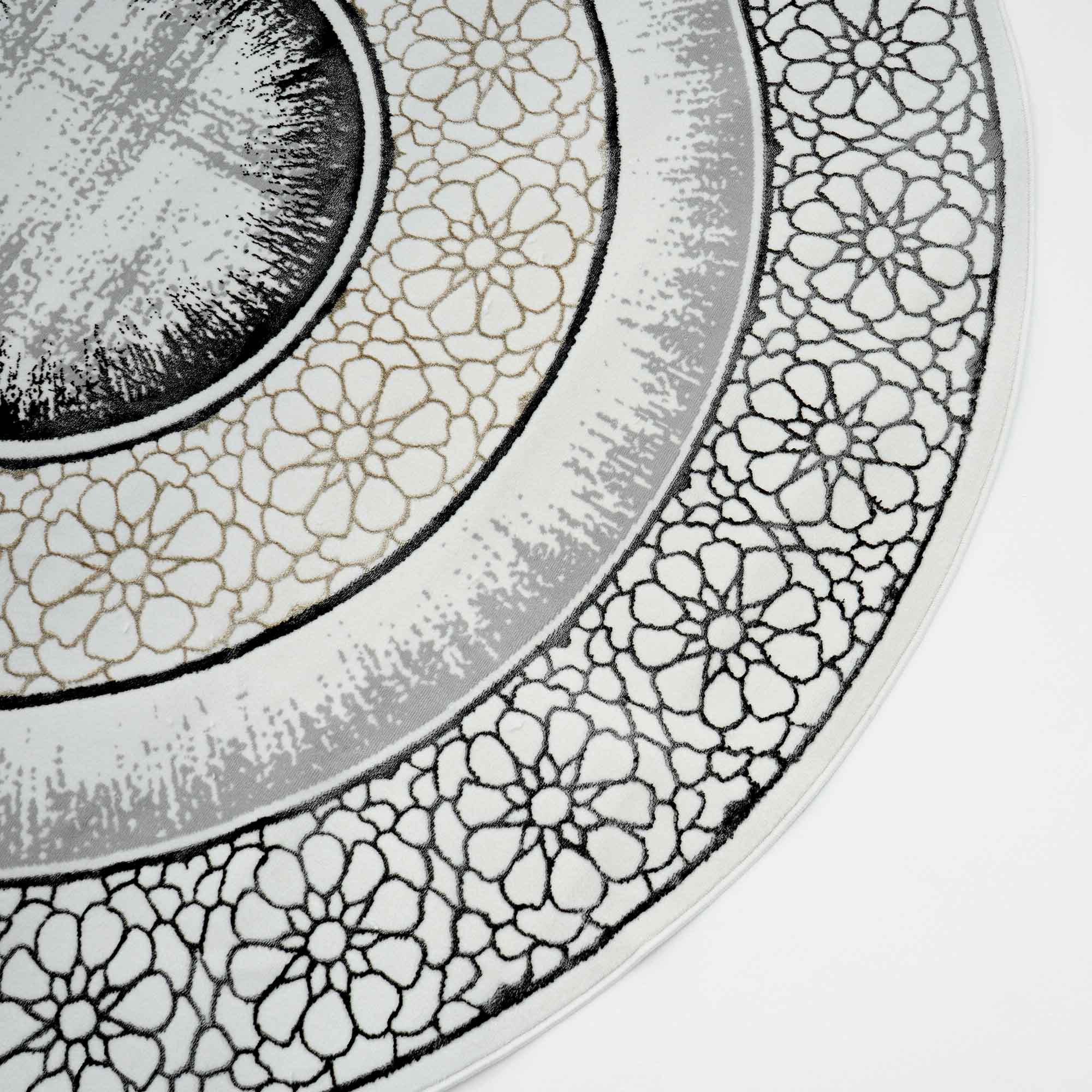 A close-up of the RAMSHA HOME Grey Color ND81A BARCELONA Decor Area Rug, showcasing concentric circles with floral and geometric patterns in black, gray, and beige on a white background.