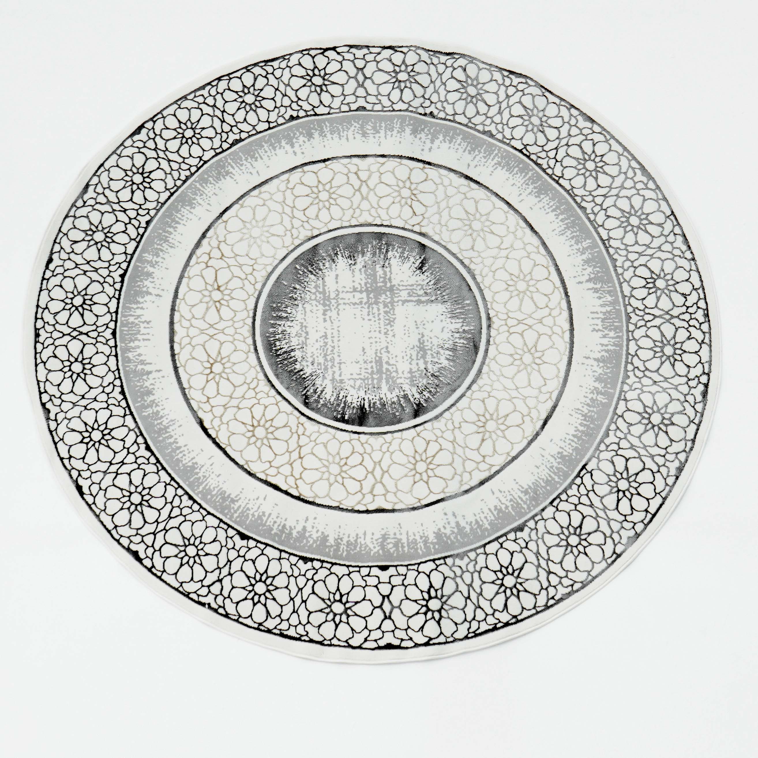 The RAMSHA HOME Grey Color ND81A BARCELONA Decor Area Rug features intricate black and gold floral patterns in concentric circles on a white background, with a central gradient effect reminiscent of an ornate decorative plate.
