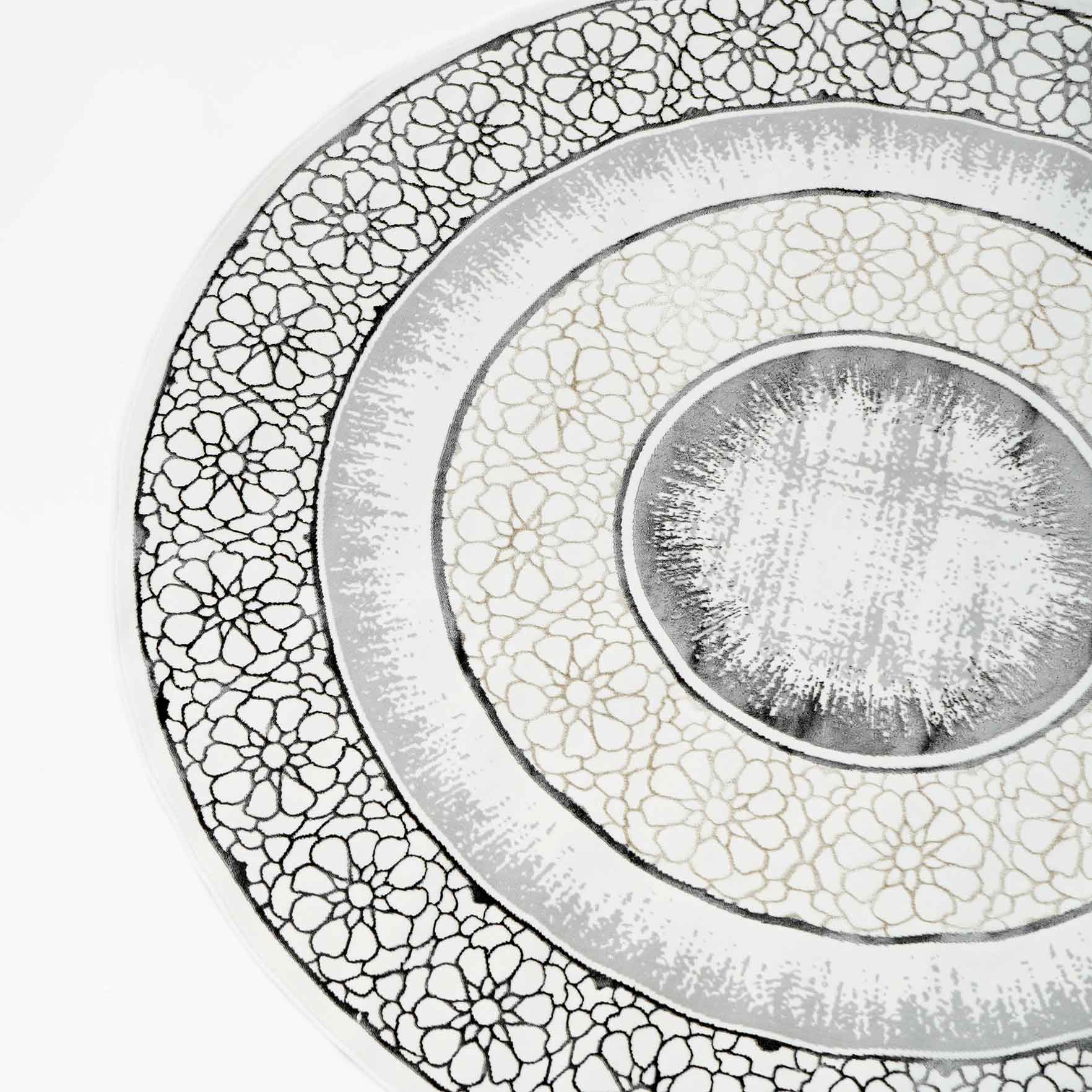The RAMSHA HOME Grey Color ND81A BARCELONA Decor Area Rug features concentric rings in gray, white, and beige with intricate floral motifs, creating a detailed, lacy design reminiscent of a decorative plate’s border.