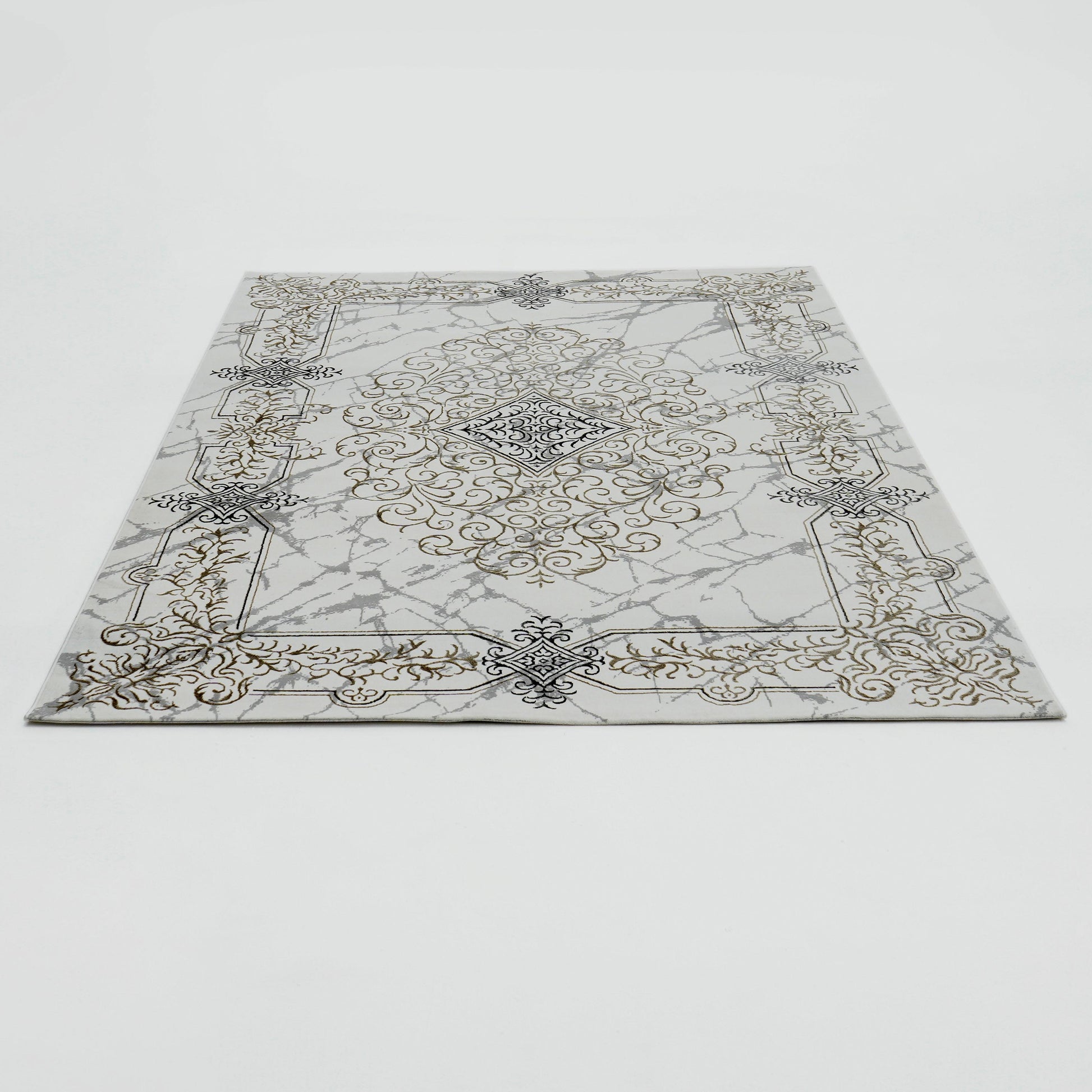 The RAMSHA HOME Beige Color Polyester NK33C Area Rug displays an ornate, symmetrical gold and dark gray pattern with scrolling details and a central medallion on a white background, laid flat on a white surface.