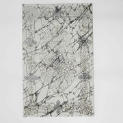 The RAMSHA HOME Beige Color Polyester NK33C Area Rug features a modern rectangular design with an ornate gold pattern on a white background, accented by black marble streaks and a central diamond motif.
