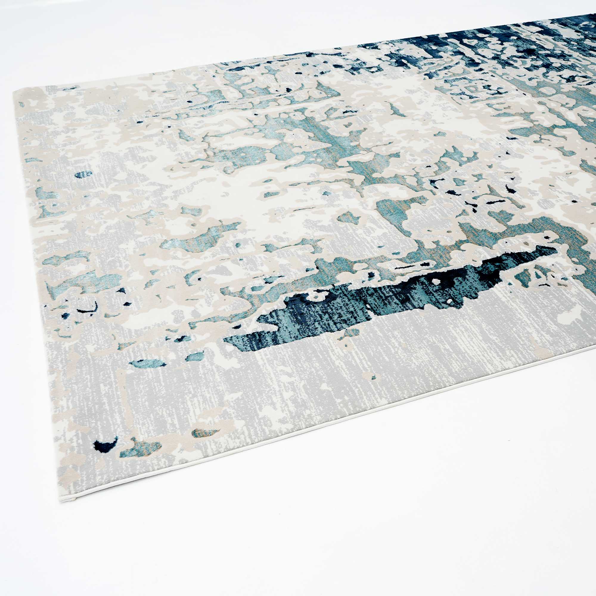 The RAMSHA HOME Light Blue Turkey Area Rug NF98B features a contemporary abstract distressed pattern in blue, teal, beige, and white, shown on a white background.