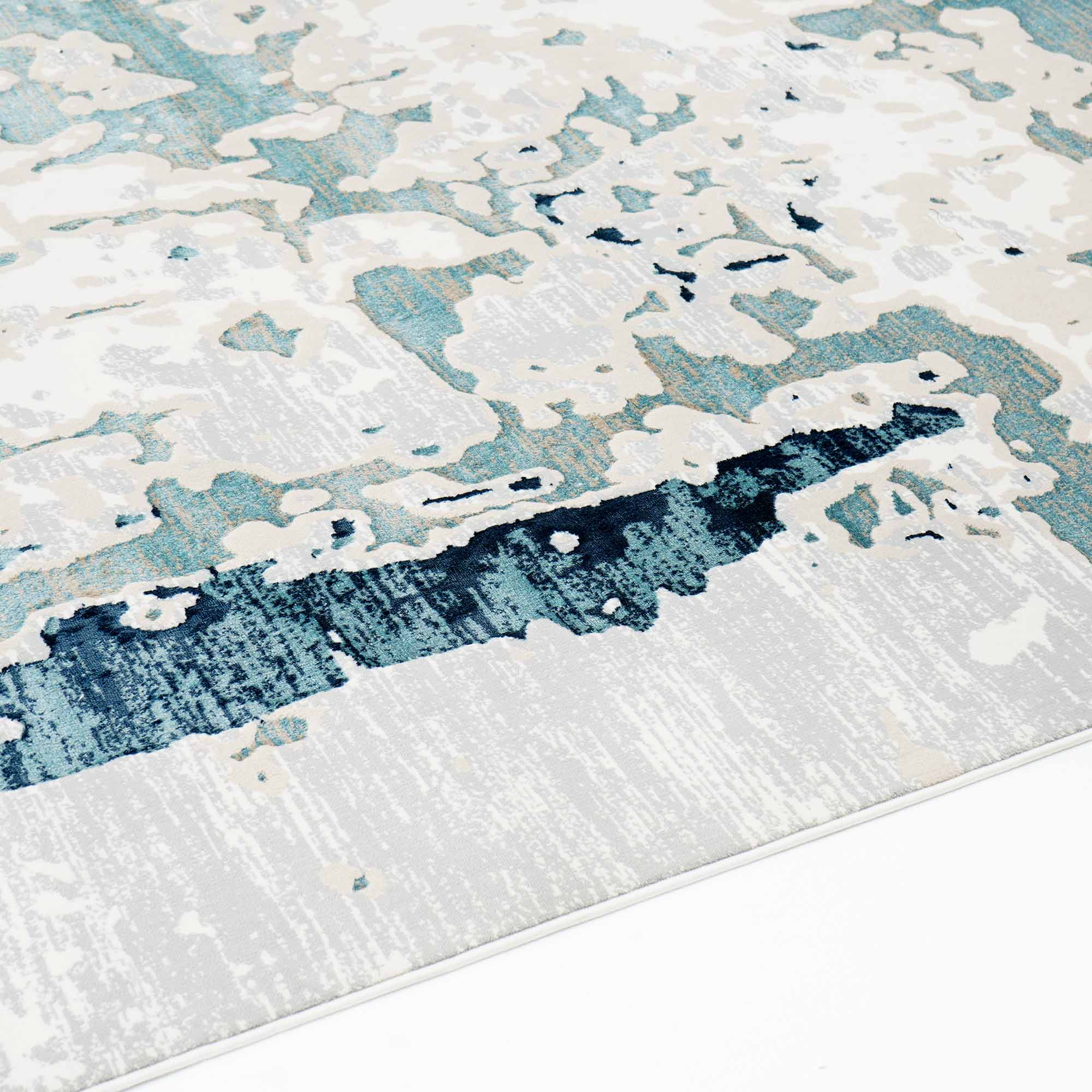 The RAMSHA HOME Light Blue Turkey Area Rug NF98B features a modern abstract pattern in shades of blue, white, and beige, with a distressed look resembling paint splashes or clouds, displayed here on a clean white floor.