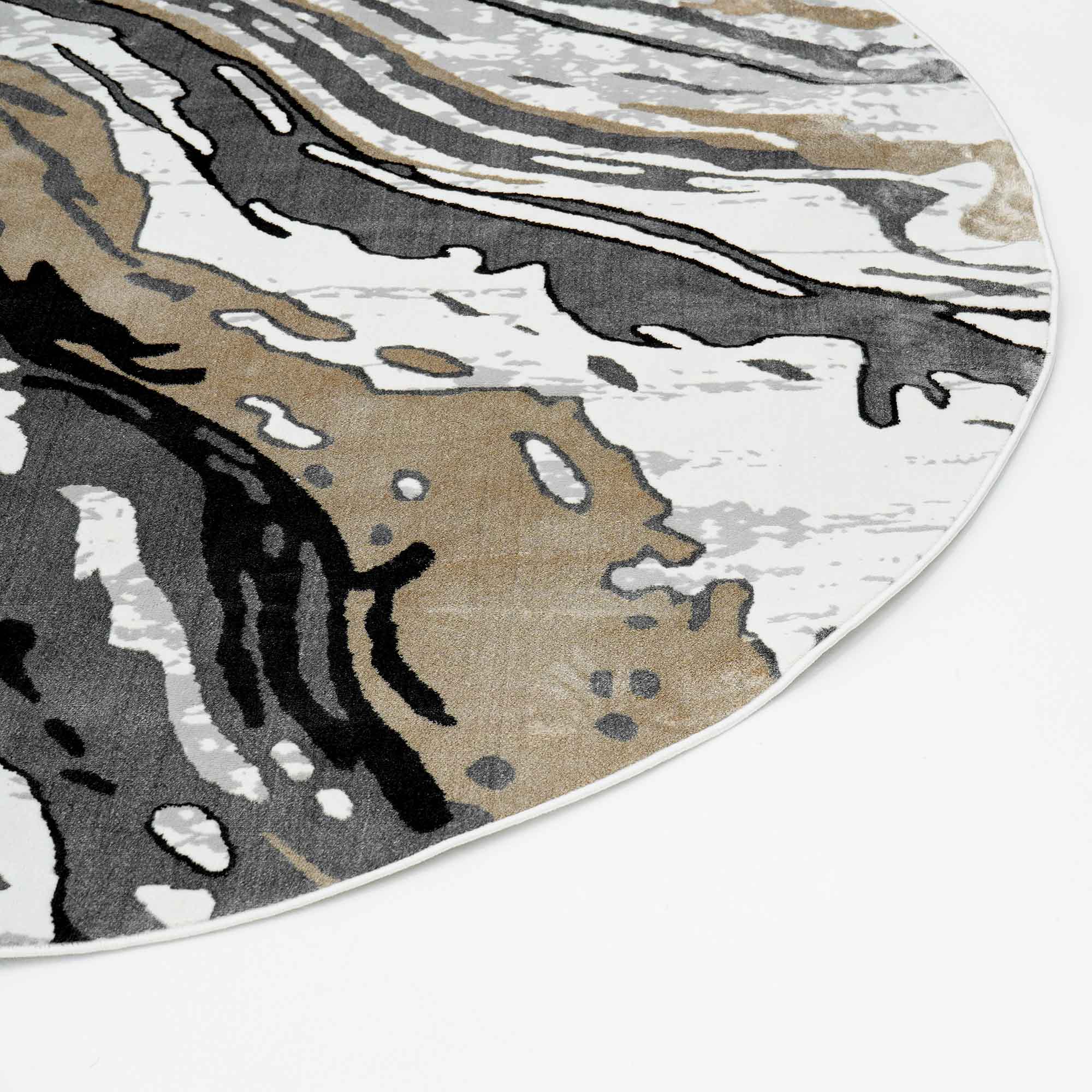 A close-up of the RAMSHA HOME Shrink Cream ND53K Polyester Decorative Floor Rug shows an eye-catching abstract round design in black, gray, beige, and white with bold, wavy lines, displayed on a white surface.
