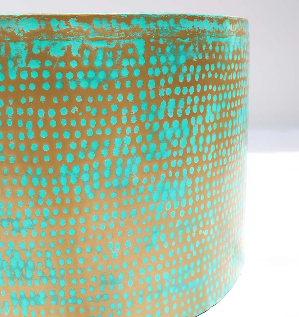 A close-up of the RAMSHA HOME Modern Round Coffee Table With Spray Platina Color GH-006, featuring a gold surface with turquoise patina and evenly spaced turquoise dots, set against a plain white background.
