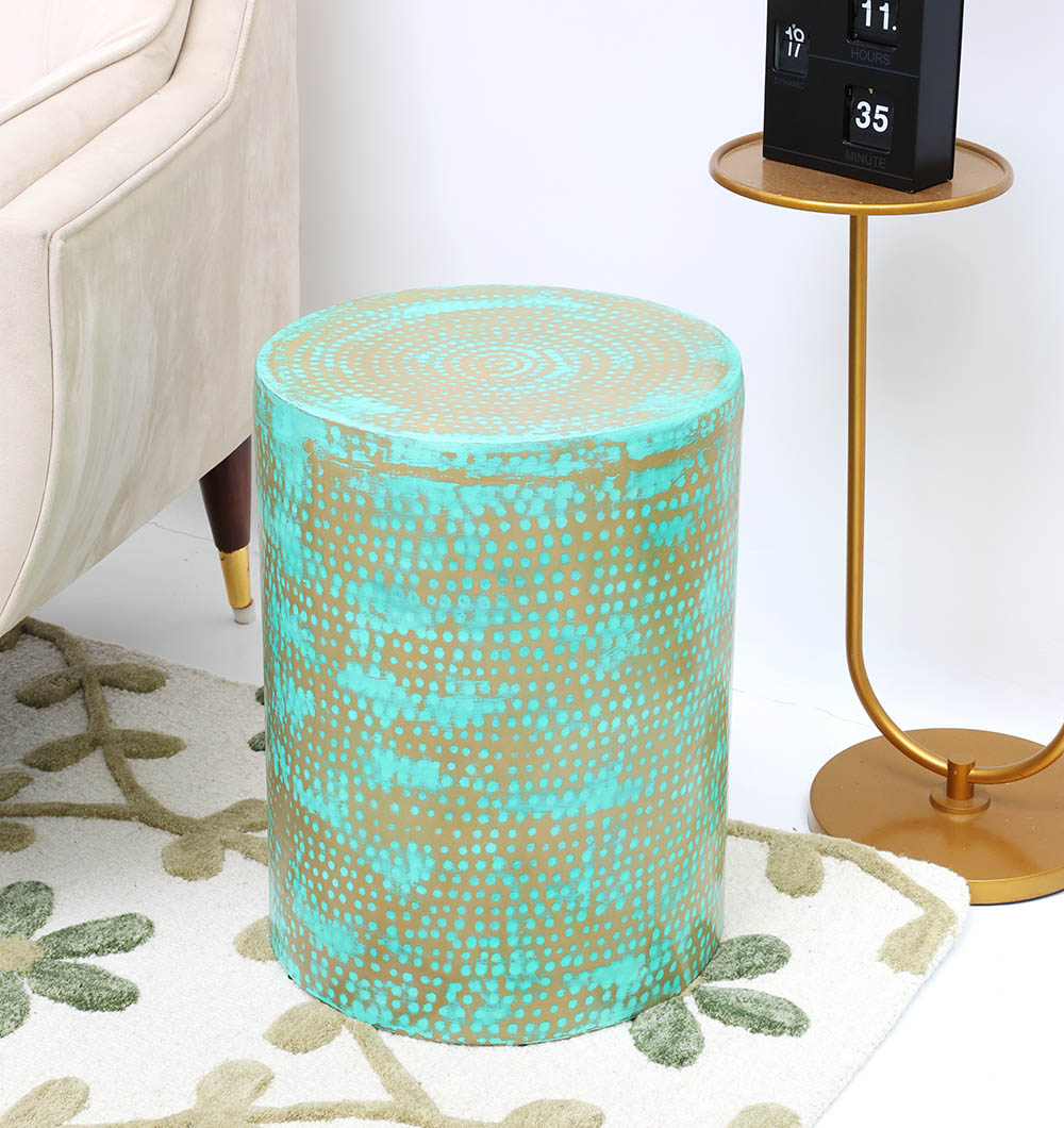 The RAMSHA HOME Modern Round Coffee Table With Spray Platina Color GH-007 stands on a floral rug beside a beige sofa and a round metal side table with a calendar.