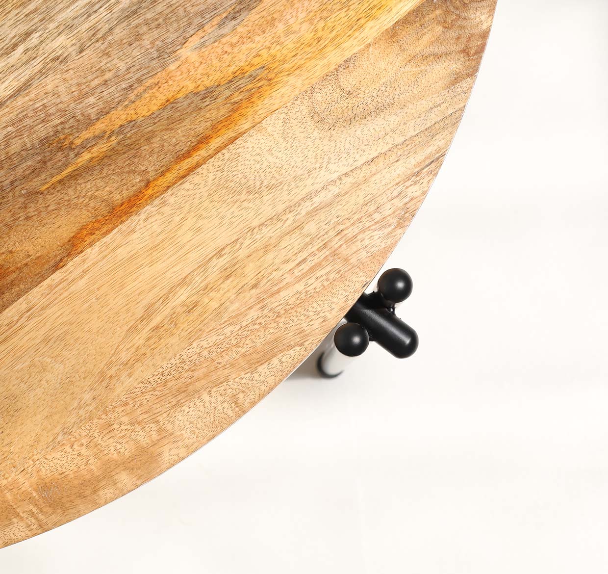 A close-up, top-down view of the RAMSHA HOME Modern Round Coffee Table – Solid Wood Top with Black Iron Legs (GH-067), displaying its natural wood grain and partially visible black iron legs against a white background.