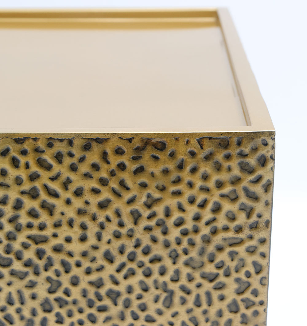 Close-up of the RAMSHA HOME Luxury Rectangle Iron Side Table GH-087, featuring a textured, gold-toned side with a black spotted pattern and a smooth top with raised edges.