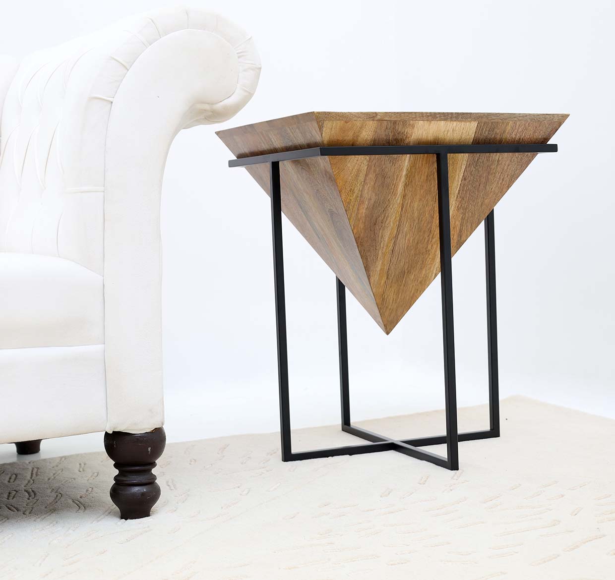 The RAMSHA HOME Modern Cone Accent Side Table (Solid Wood & Iron Base GH-091) features a natural wood inverted pyramid top and black metal frame, perfect beside a white tufted sofa on a light-colored rug.