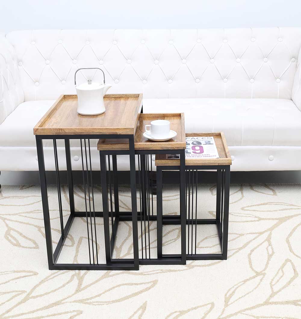 RAMSHA HOME’s Modern Three-Tier Side Tables (Natural/Black Powder Finish, Black Iron Base GH-099-A) are arranged in front of a white tufted sofa; the largest holds a teapot, the middle a cup and saucer, and the smallest a folded newspaper.