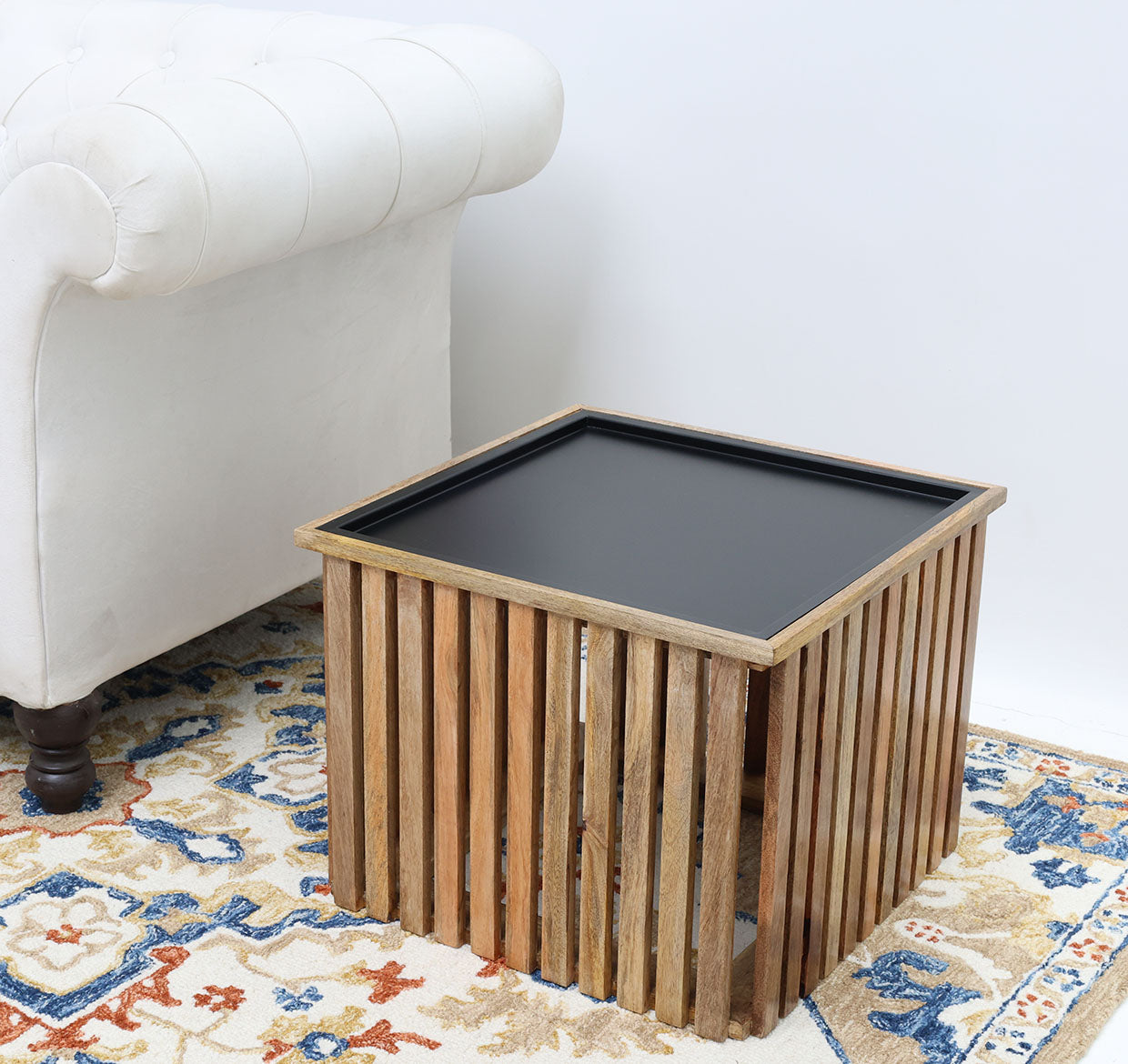 Modern square coffee table with slatted wooden top and iron base.