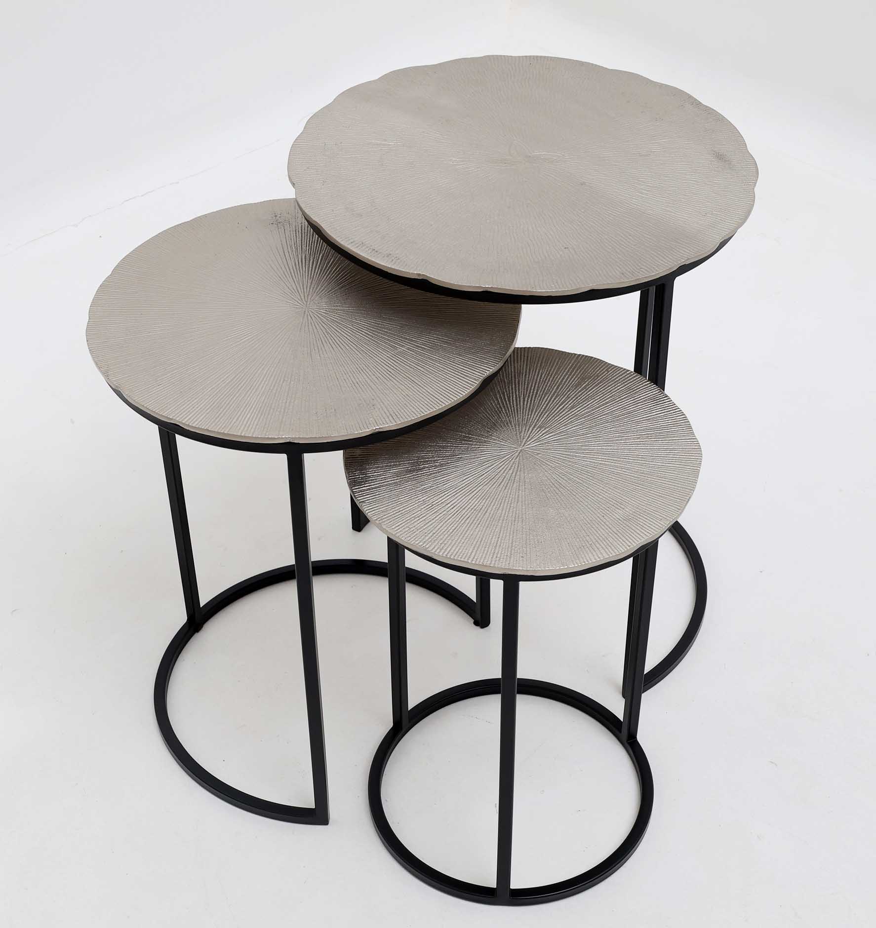The RAMSHA HOME Set of 3 Modern Nesting Side Tables (GH-111-A) features antique brass tops and a grey iron base. These stylish tables are shown arranged together, varying in size to fit neatly under each other.