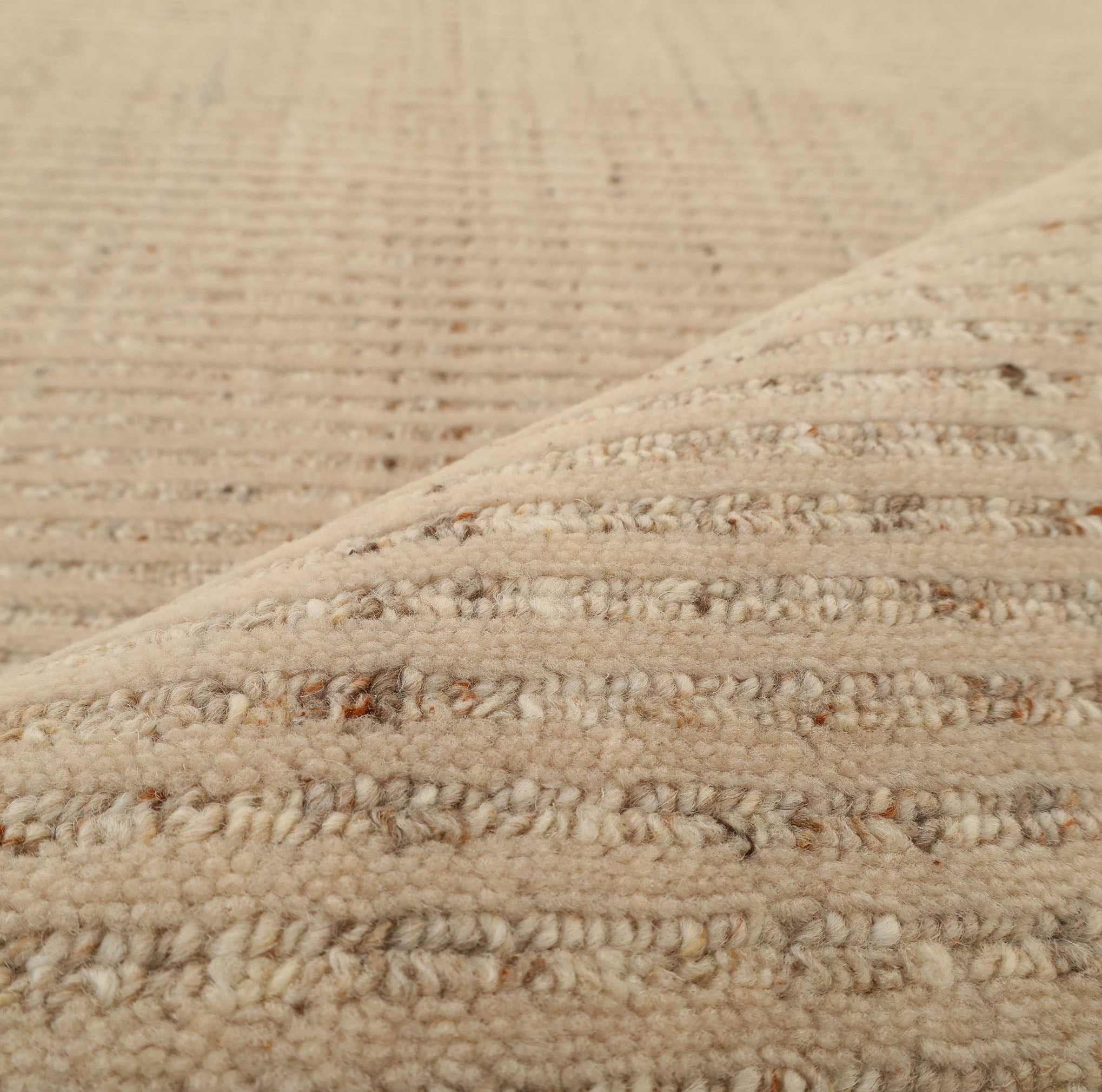 Close-up of the Handmade Natural Wool Rug – Textured Beige Area Rug (HLR-002) by RAMSHA HOME shows its thick, soft, looped fibers and subtle stripe pattern—ideal for adding minimalist charm to your space.