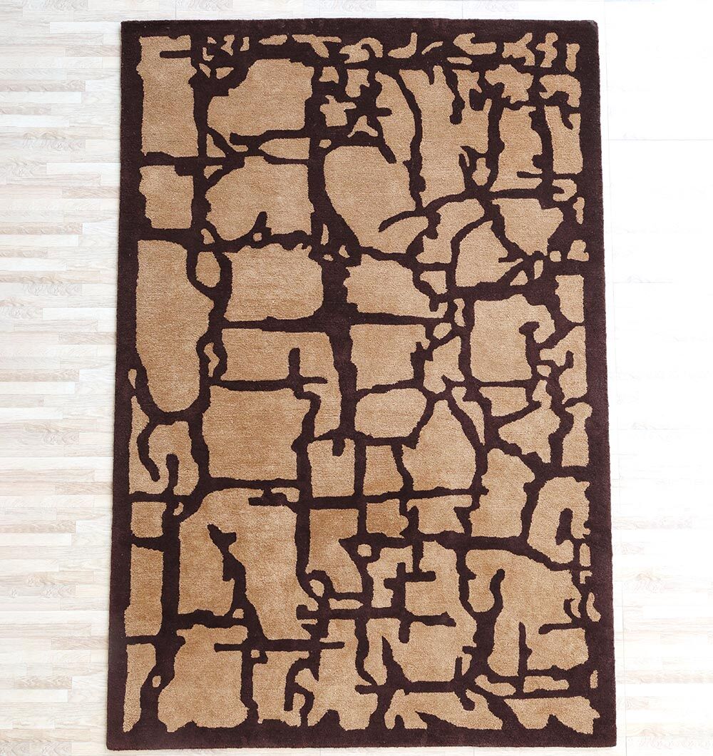 The RAMSHA HOME Multi Handmade Area Rug - HTP 21 (200x300cm) features a beige base with abstract dark brown patterns, adding modern style and sophistication to contemporary spaces with light wood flooring.
