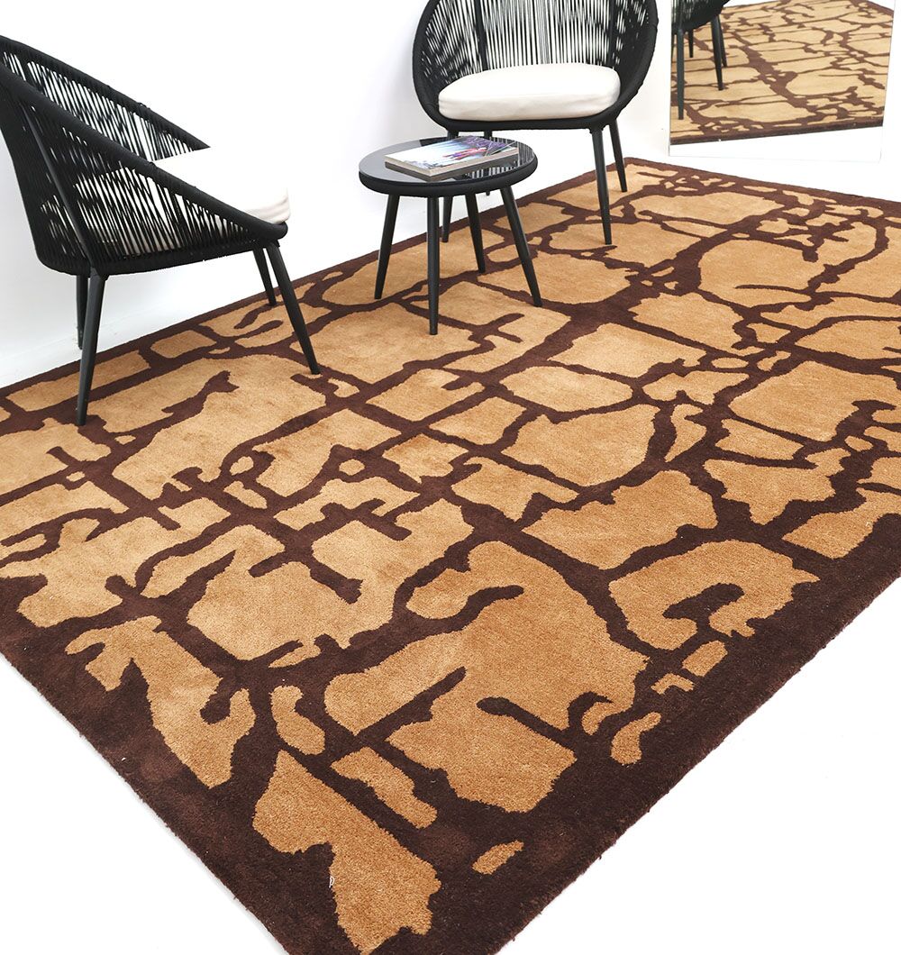 A modern room showcases the RAMSHA HOME Multi Handmade Area Rug - HTP 21 (200x300cm), two black woven chairs with white cushions, and a small round black table with books, beside a mirror reflecting the rug’s abstract design.