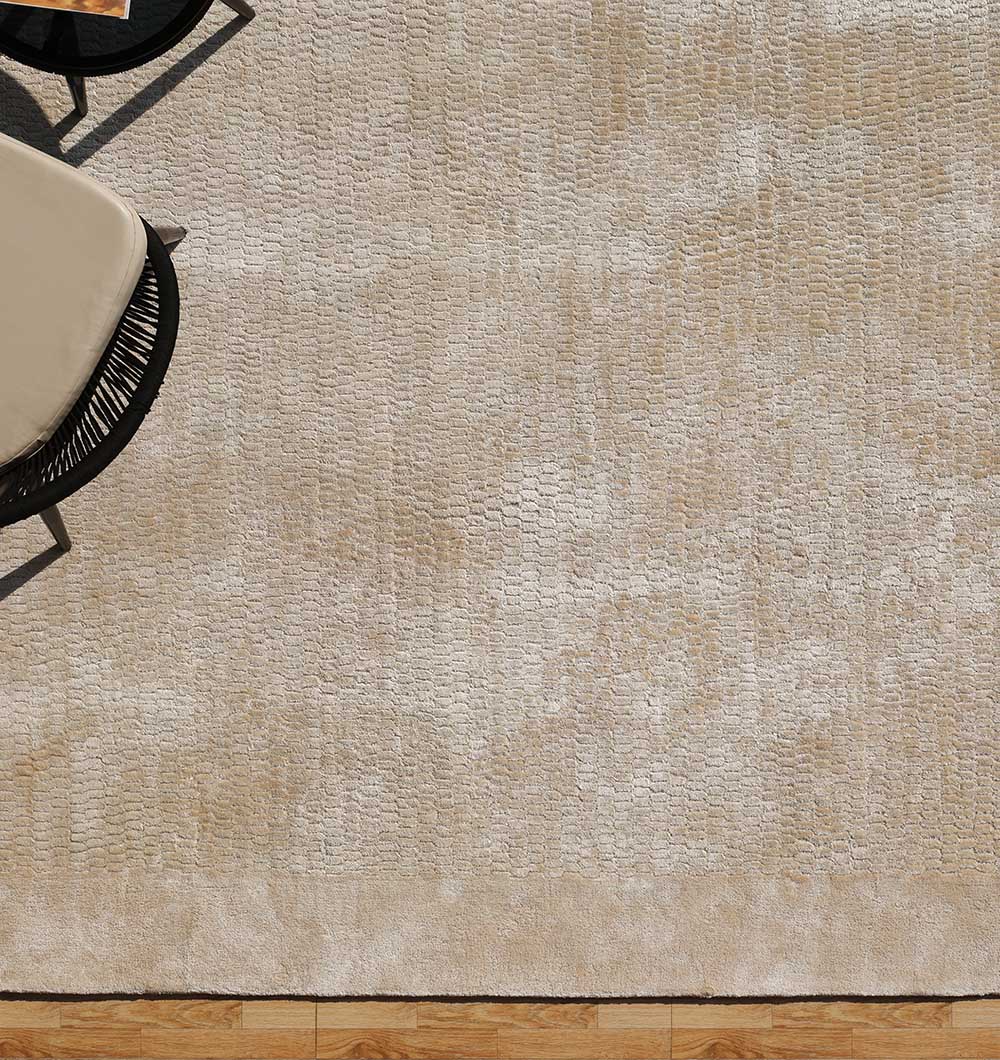 The RAMSHA HOME Beige Color Handmade Area Rug - HTV 20 (300x400 cm), featuring a subtle textured pattern, is displayed beside tan-cushioned black furniture on a wooden floor.