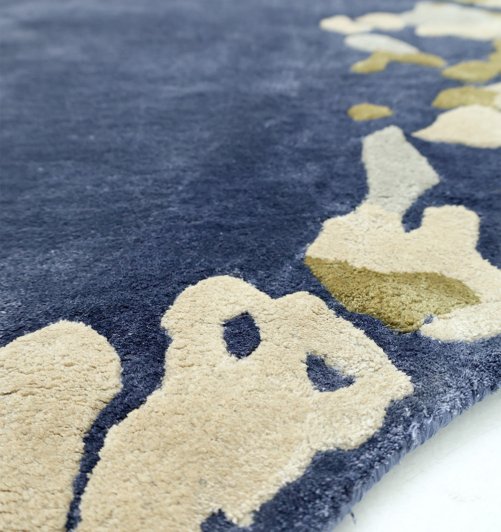 Close-up of the RAMSHA HOME Navy Blue Viscose Shaped Handmade Carpet 200x300 (HTV-23), featuring plush, thick texture and cream and light brown abstract patterns along the edge.