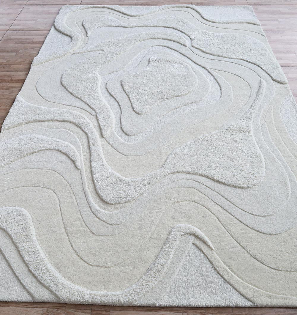 The RAMSHA HOME Luxury Off White Handmade Area Rug - HTW 114 (200x300 cm) features textured, wavy patterns reminiscent of topographic lines, adding depth and warmth to your space on a light wood floor.