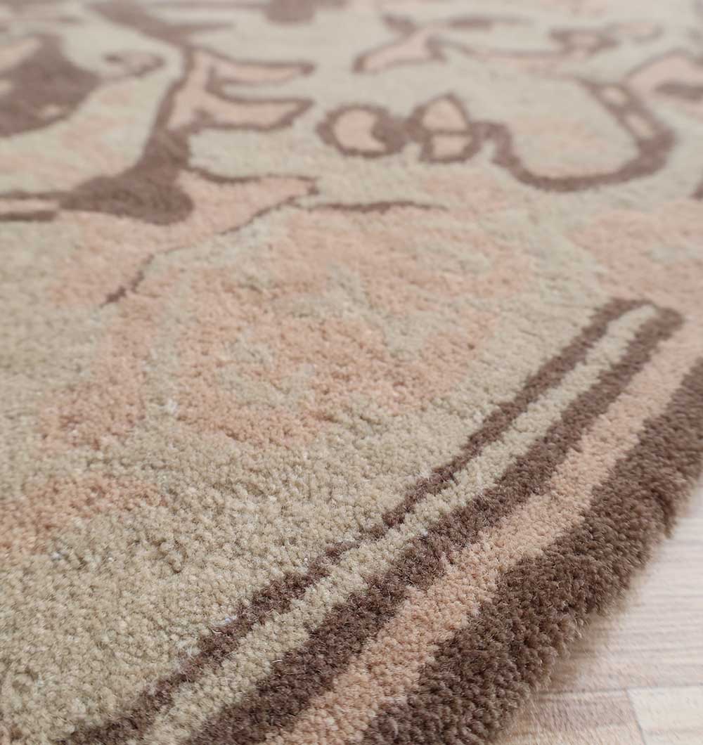Close-up view of the RAMSHA HOME Handmade Cotton Round Wool Rug HTW 122 (150cm) featuring soft, plush pile in light beige, tan, and brown tones with a subtle abstract pattern, placed on light wood flooring.