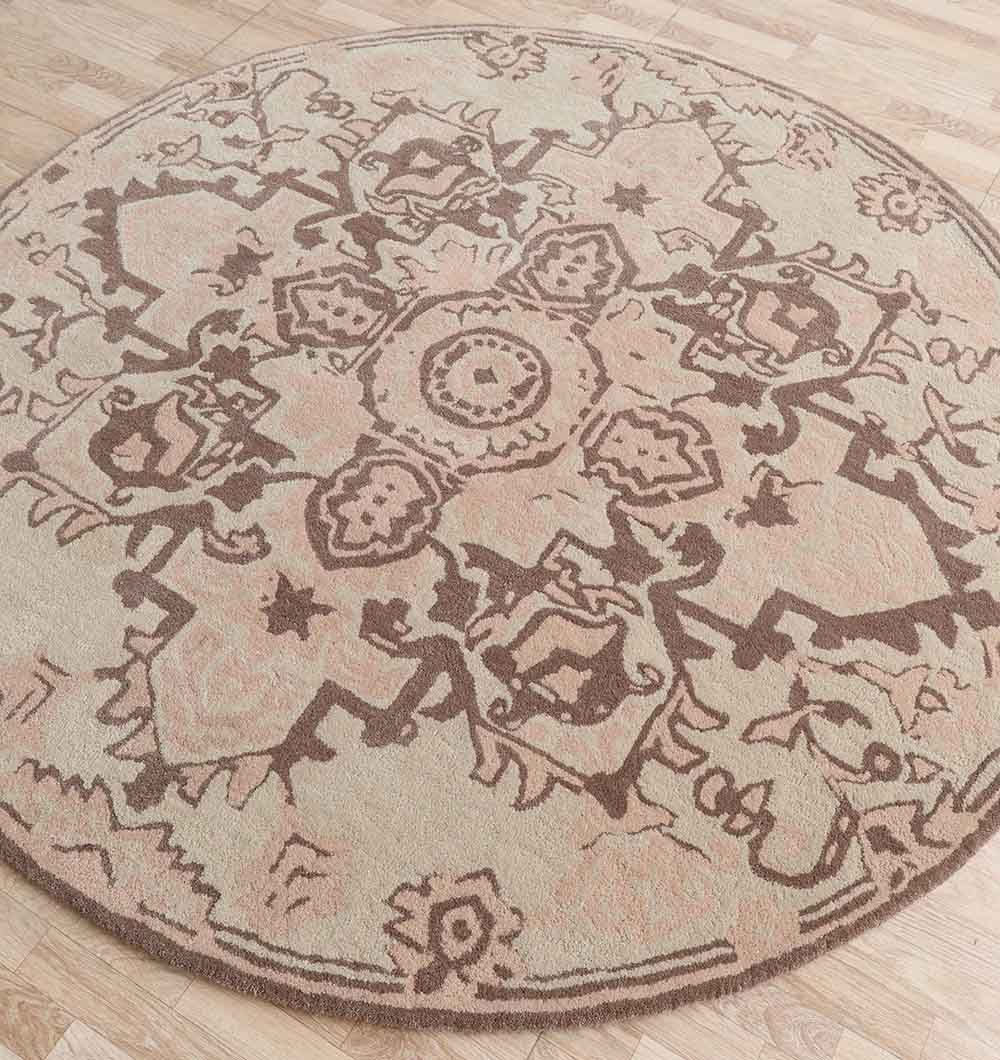 The RAMSHA HOME Handmade Cotton Round Wool Rug HTW 122 (150cm) features a beige background with brown geometric and floral medallion patterns, shown on a light wood floor.