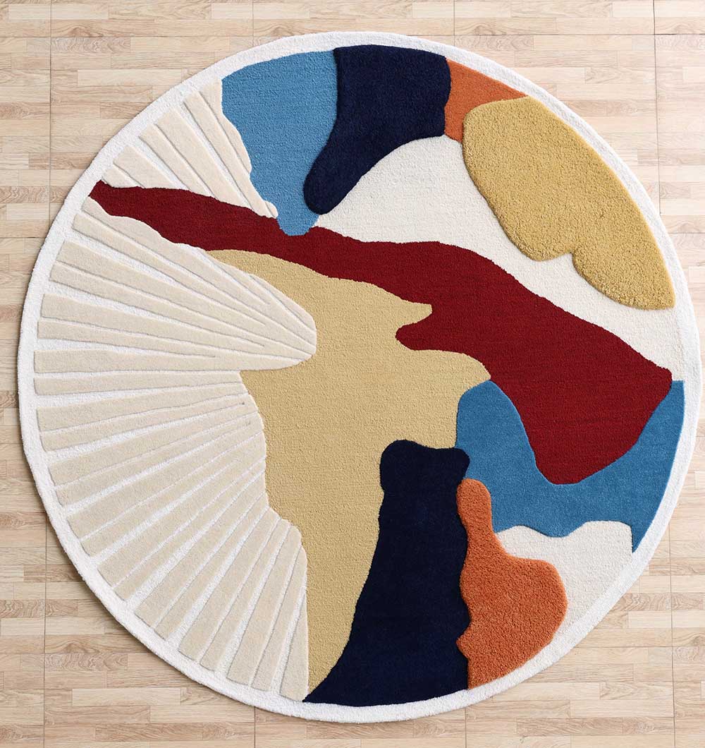 The RAMSHA HOME Handmade Wool & Cotton Abstract Round Area Rug HTW 125 (200cm) features organic forms in cream, mustard yellow, navy blue, red, orange, and light blue with radiant lines—perfect for a modern look on light wood floors.