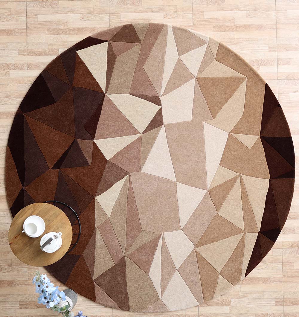 The RAMSHA HOME Handmade Multicolor Geometric Pattern Round Area Rug HTW 129 (200cm) adds style to the light wooden floor, with a small round wooden table, two white cups, and a flower vase partly placed on the vibrant rug.