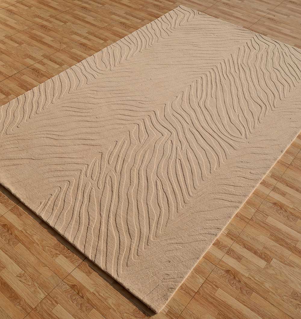 The RAMSHA HOME Rectangle Shape Beige Handmade Area Rug - HTW 133 (200x300 cm) features a wavy textured pattern, adding depth and blending seamlessly with modern interiors on light brown wood-patterned floors.
