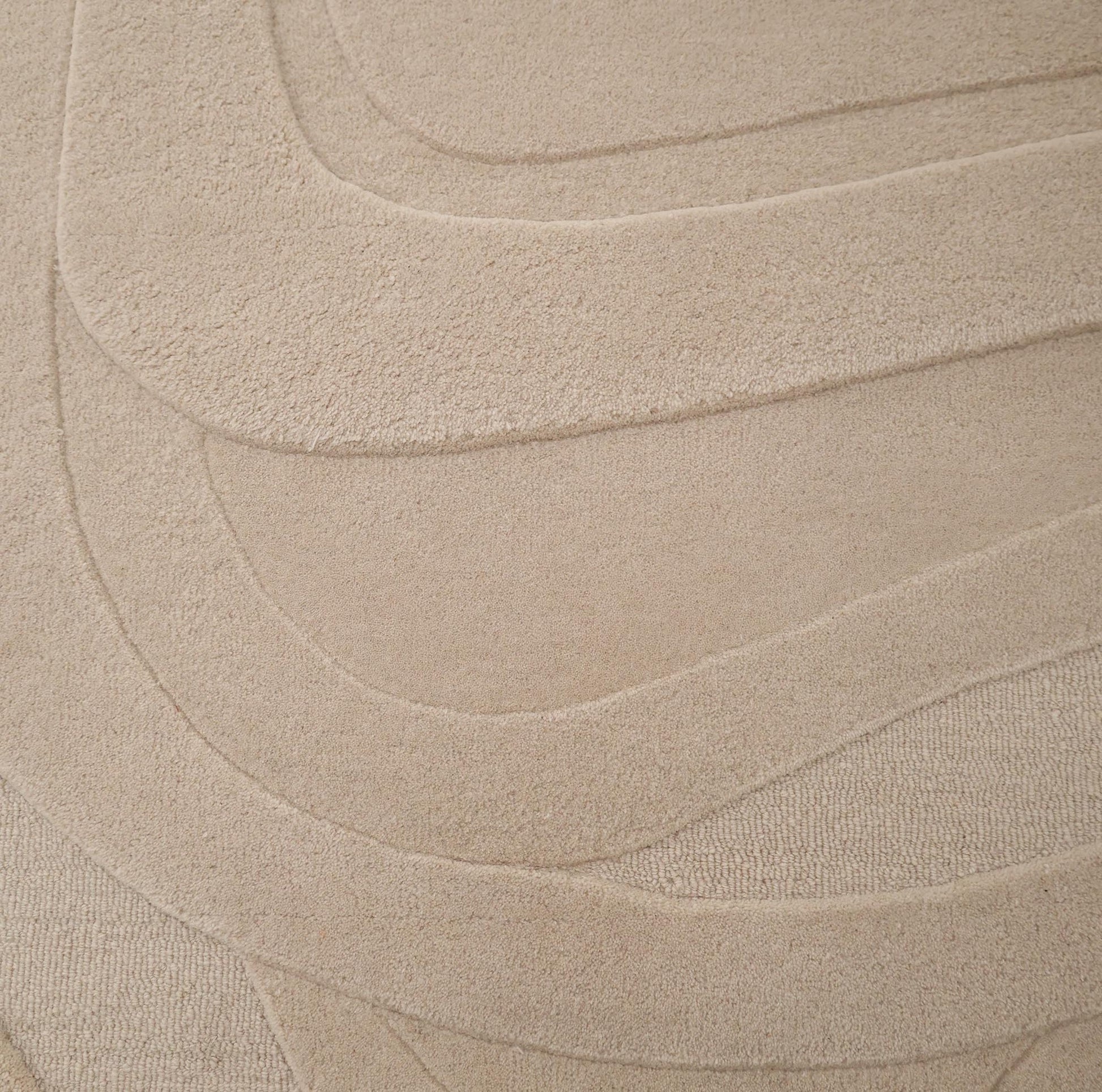 The RAMSHA HOME Contemporary Flow Area Handmade Rug HTW-146 showcases a subtle, layered wavy pattern and textured surface, offering a soft, abstract modern beige design inspired by topographic forms.
