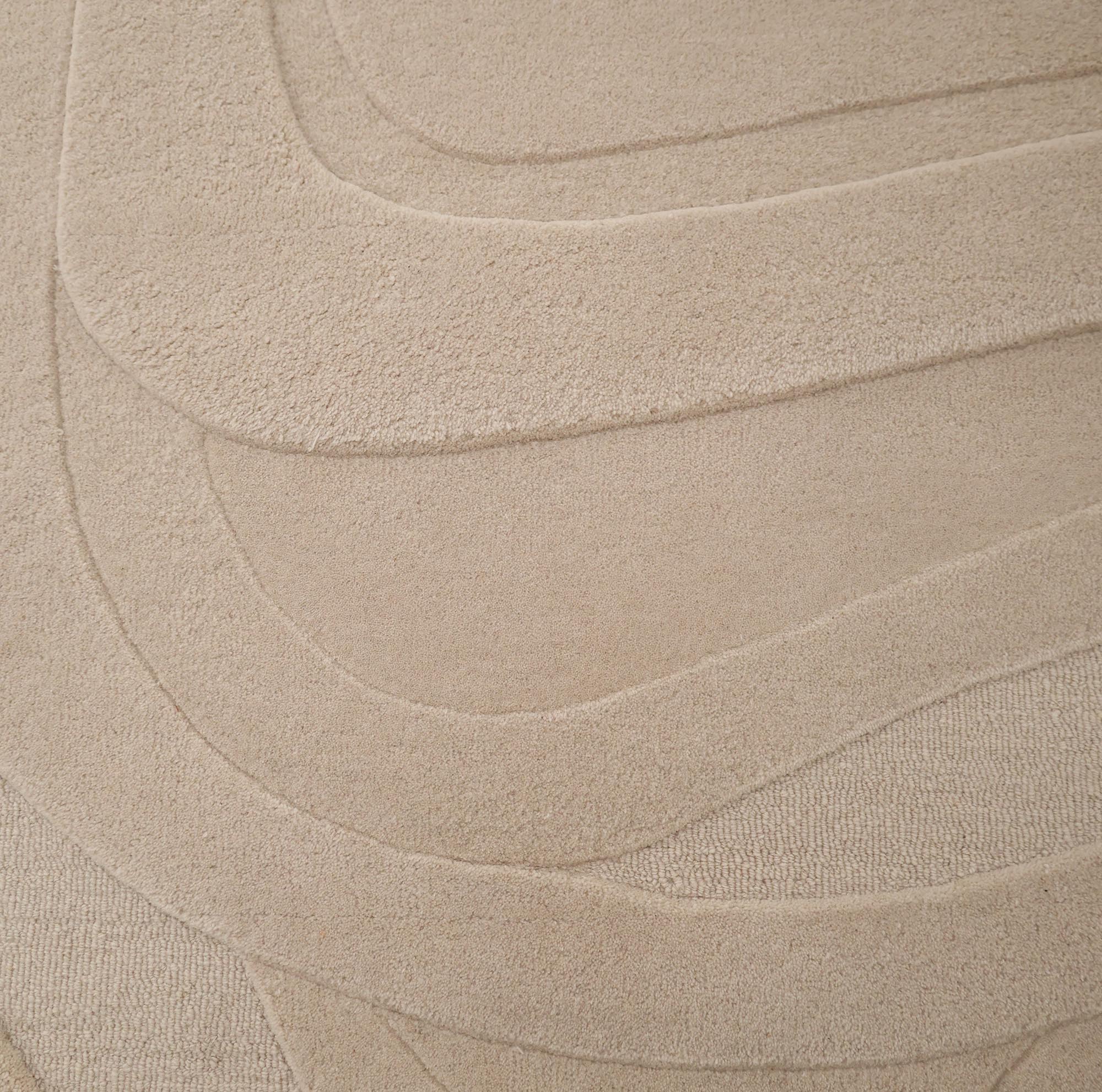 The RAMSHA HOME Contemporary Flow Area Handmade Rug HTW-146 showcases a subtle, layered wavy pattern and textured surface, offering a soft, abstract modern beige design inspired by topographic forms.