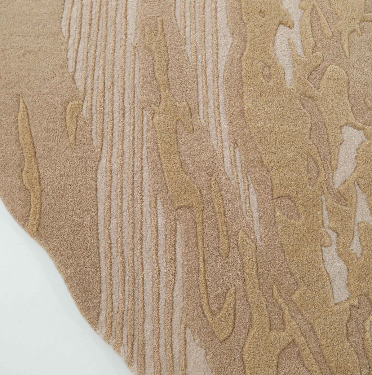 Close-up of the RAMSHA HOME Abstract Beige Rug – Neutral Textured Modern Area Rug with Organic Pattern (HTW 156), featuring abstract, organic designs and raised lines that create a wavy, natural texture. The edge of the rug and a portion of white flooring are visible.