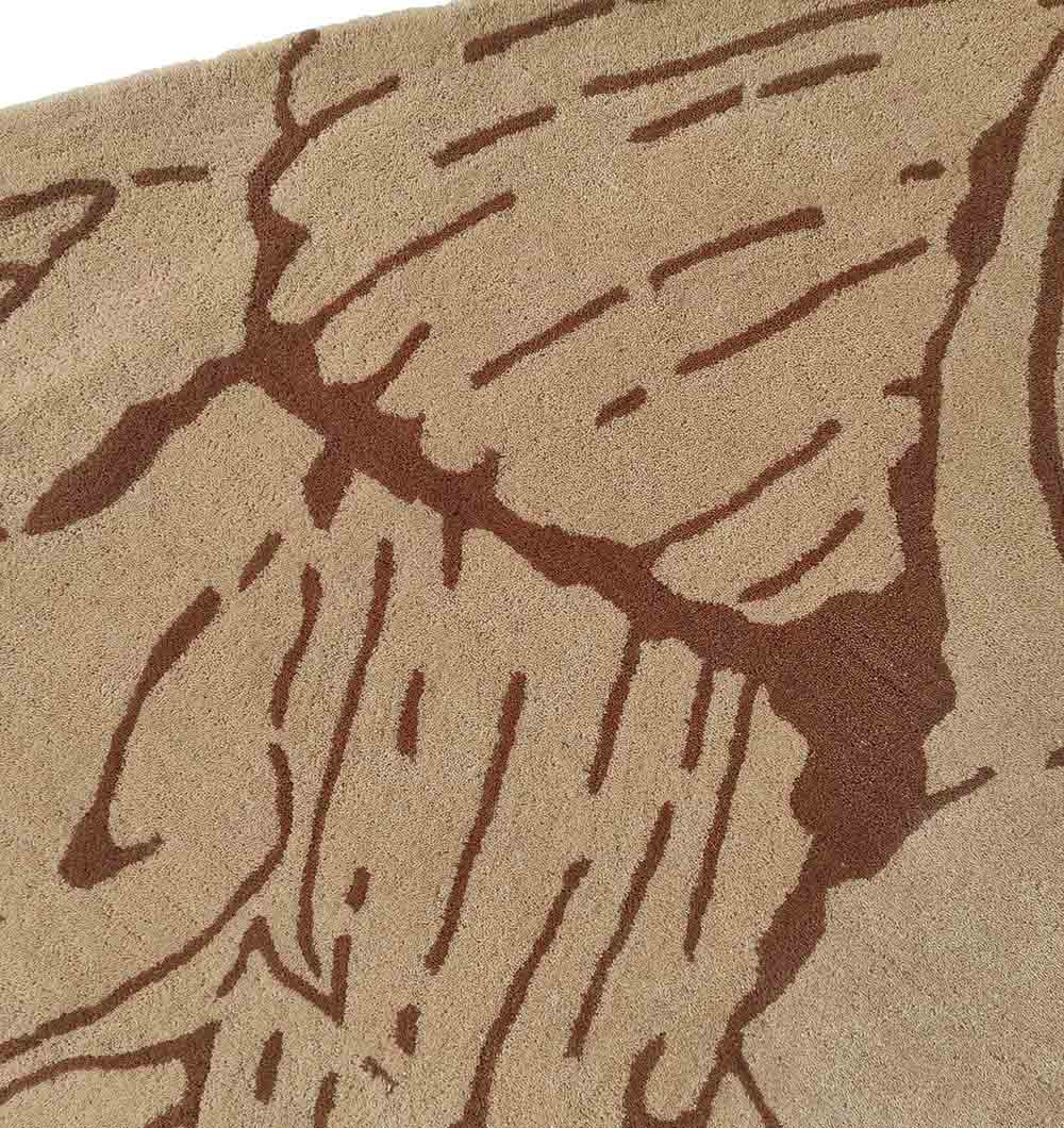 Close-up of the RAMSHA HOME Premium Off-White Area Carpet - HTW 42 (250x350 cm), showcasing dark brown abstract lines and shapes for an organic, modern look—ideal as an irregular wool rug in contemporary spaces.