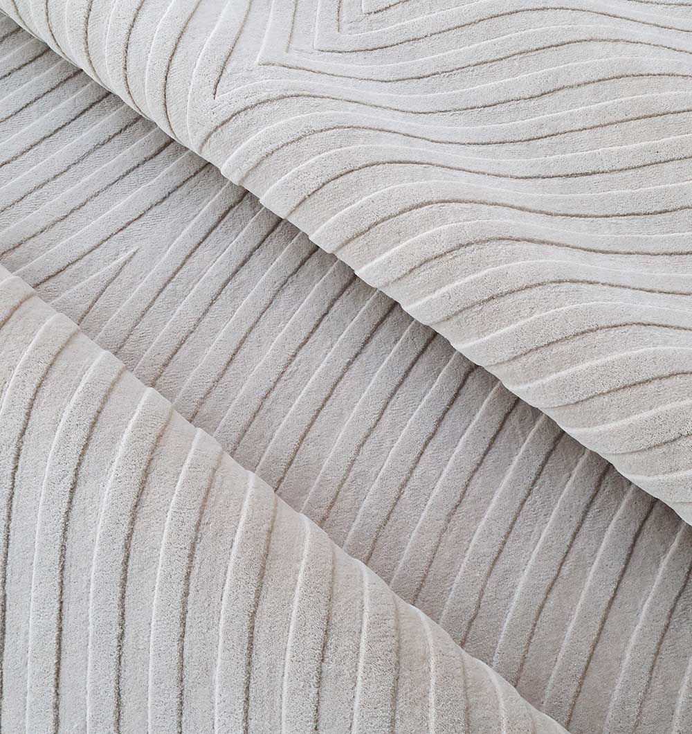 Close-up of the Off White Color Decor Area Rug - HTW-95 (300x400 CM) by RAMSHA HOME, highlighting its soft, suede-like hand-tufted texture with raised, wavy diagonal lines for a modern tactile look.