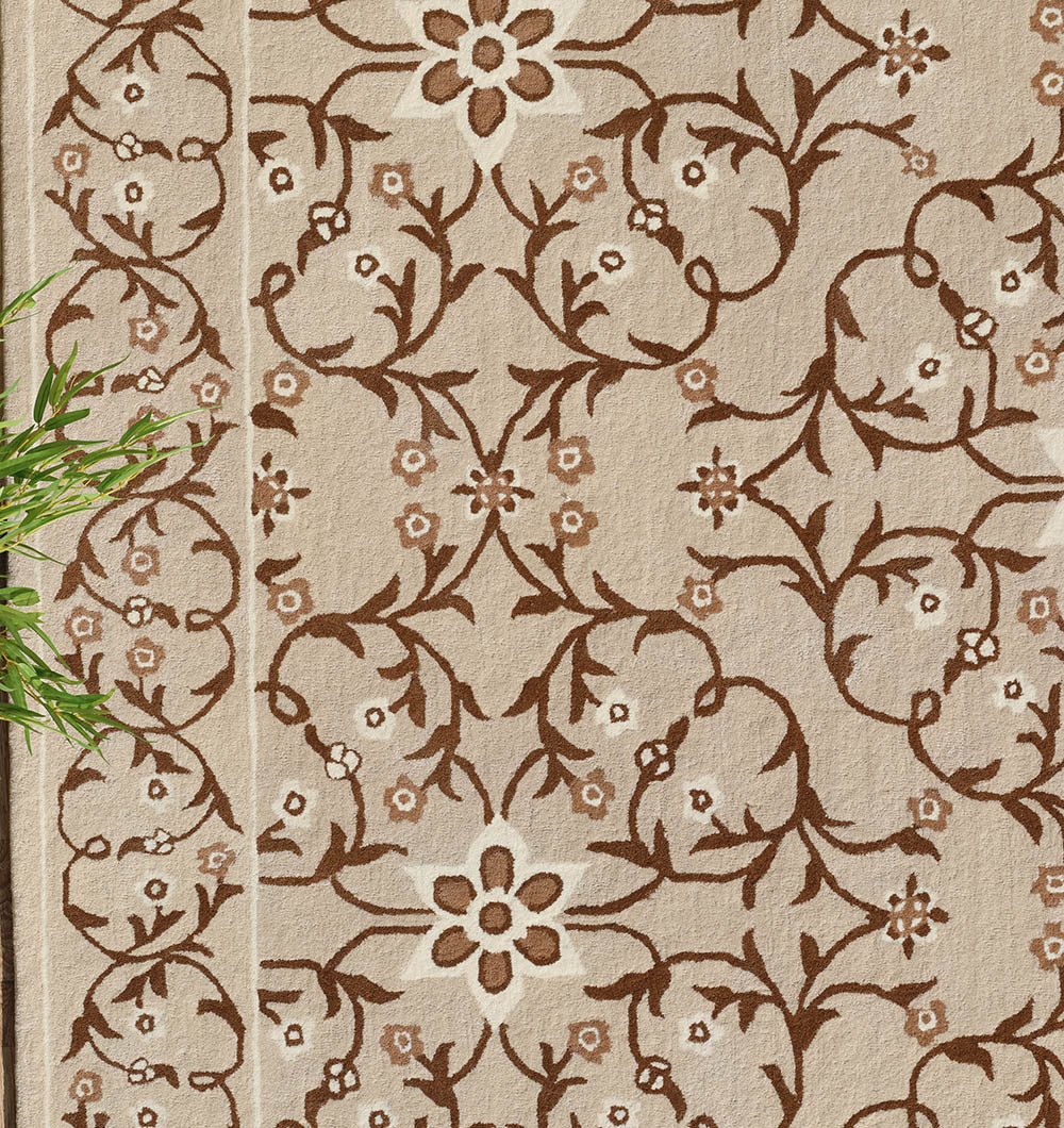 The Exquisite Multi Color Decor Handmade Rug - HTW 99 (300x400 CM) by RAMSHA HOME features a beige hand tufted wool base with ornate brown floral and vine patterns and large, small flowers on curved stems. A green leafy plant appears in the lower left.