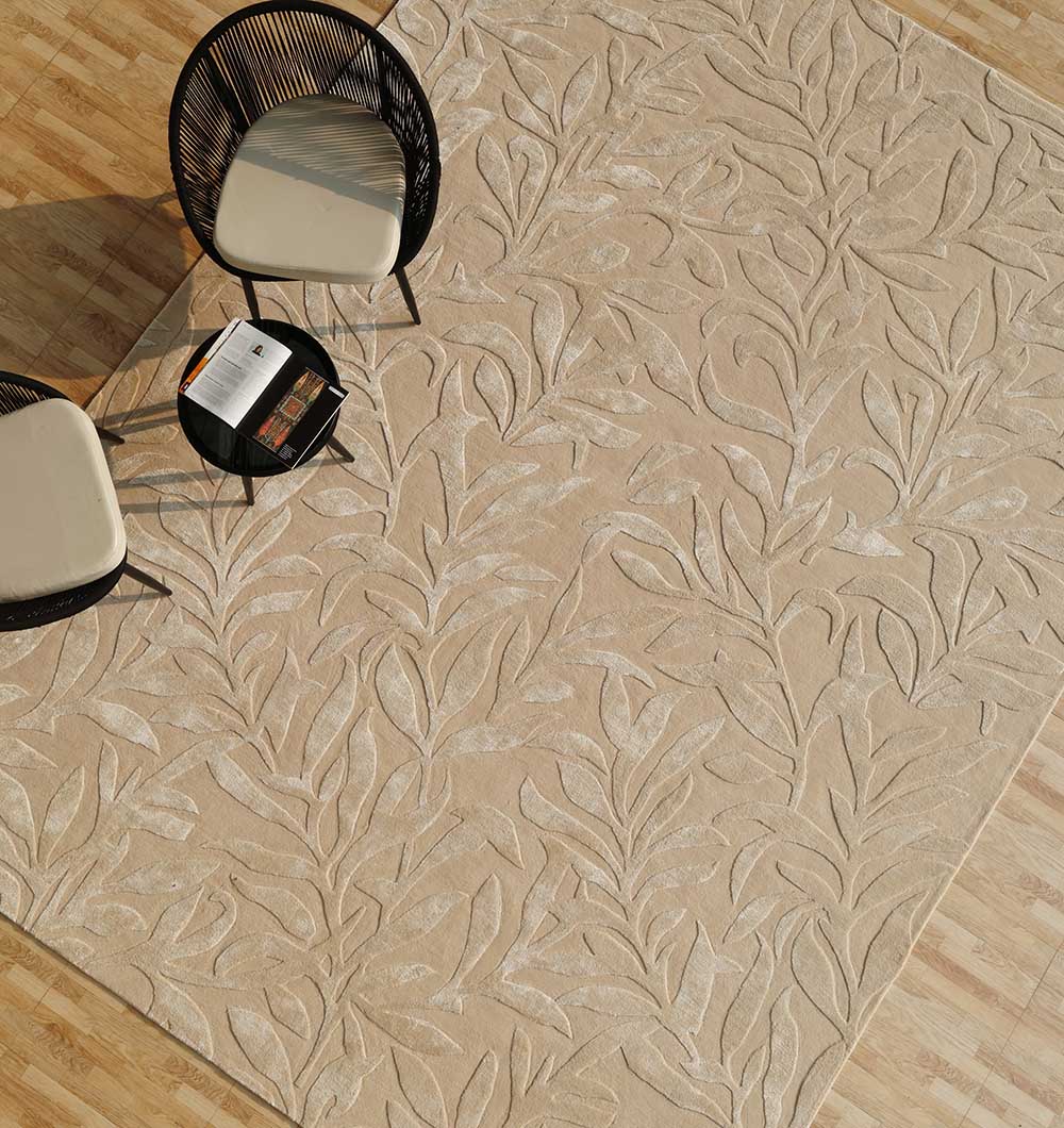 Top-down view of the rectangular rug under a table and chairs, showcasing its intricate design and beige color palette.