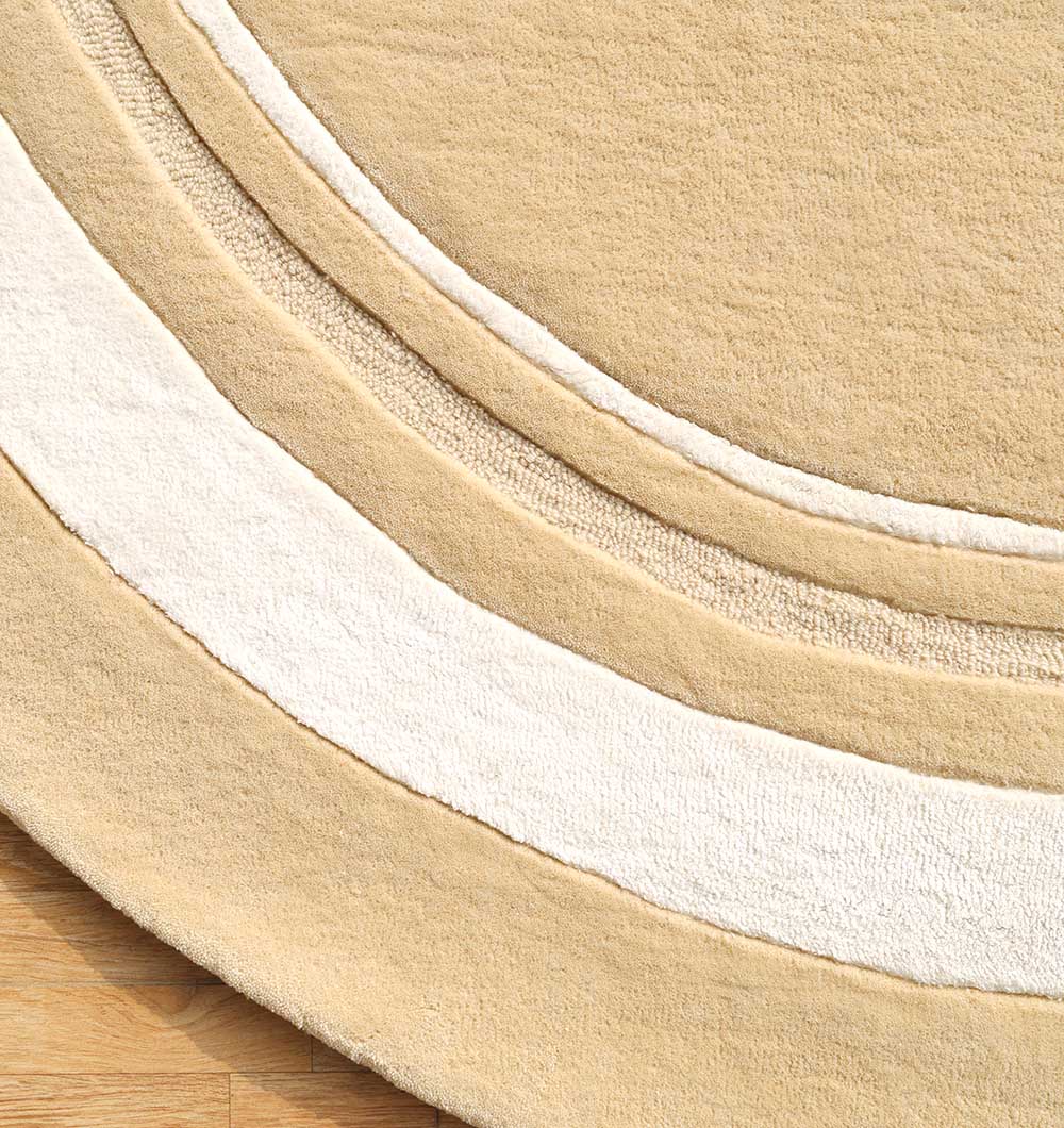 The RAMSHA HOME Multi Color Handmade Rug (HTWV-120) features raised textured arcs and layered patterns in soft wool, handtufted for a modern look and shown on a wooden floor.