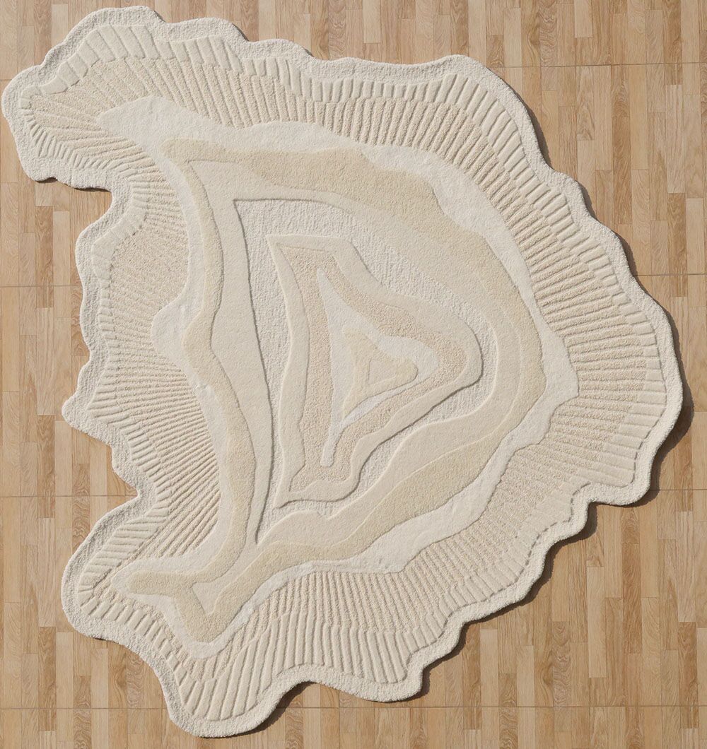 The RAMSHA HOME Natural Handmade Area Rug - HTWV-126 features a cream and beige, irregular shape with wavy, layered patterns and uneven edges, resembling a topographical map—a striking neutral wool blend accent for light wood floors.