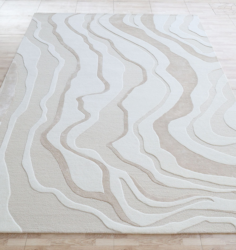 The RAMSHA HOME Handcrafted Living Room Area Rug – HTWV-127 features modern cream and beige wavy lines, creating a topographic look. Perfect on light wood floors, this neutral rug adds a stylish, contemporary touch to any space.