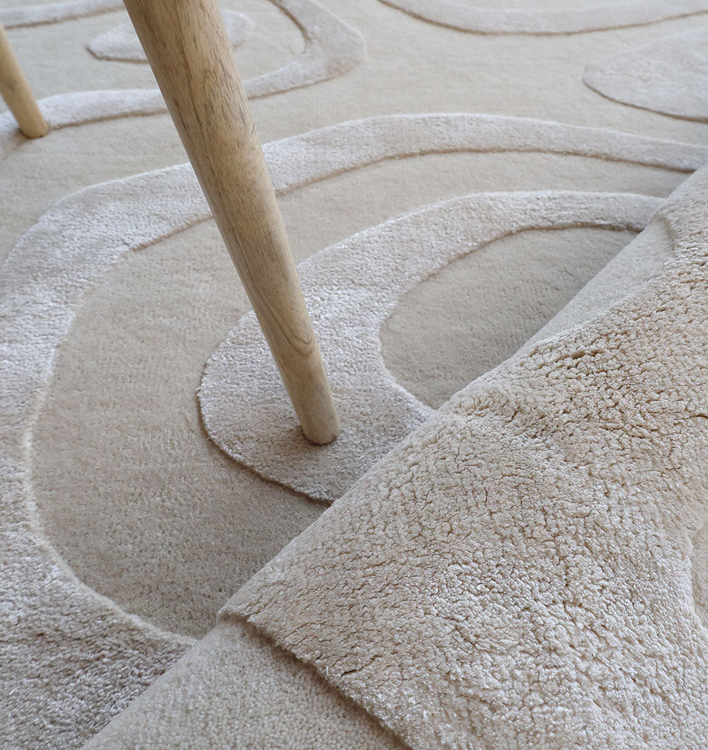 Close-up of the multi-color wool blend texture next to home decor items, showcasing its versatile look.