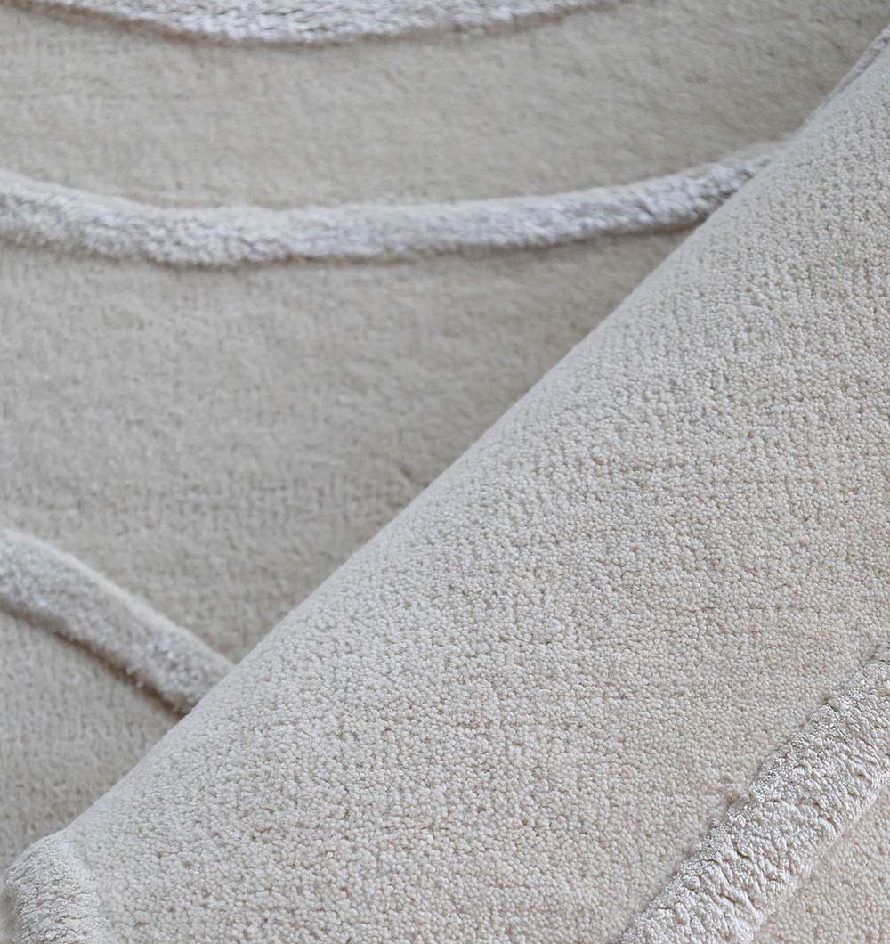 Close-up of the RAMSHA HOME Multi Color Handmade Area Rug - HTWV-133, showing its soft, plush hand-tufted wool and textured curved pattern with raised design details.