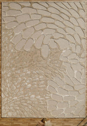 The RAMSHA HOME Organic Flow Hand-Tufted Rug – Soothing Beige Textured Elegance HTWV-134 features an abstract pebble pattern and is shown on a wooden floor, with a fluffy accent and a gold pole at the bottom edge.