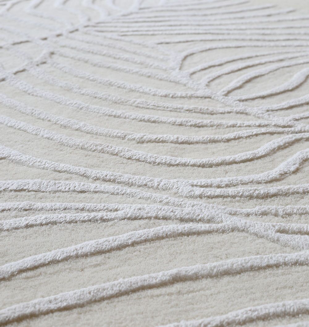 Close-up of the Off White Color Handmade Area Rug - HTWV-140 (200x300 cm) by RAMSHA HOME, featuring a textured surface with raised, wavy lines forming an abstract pattern that evokes organic leaf veins.