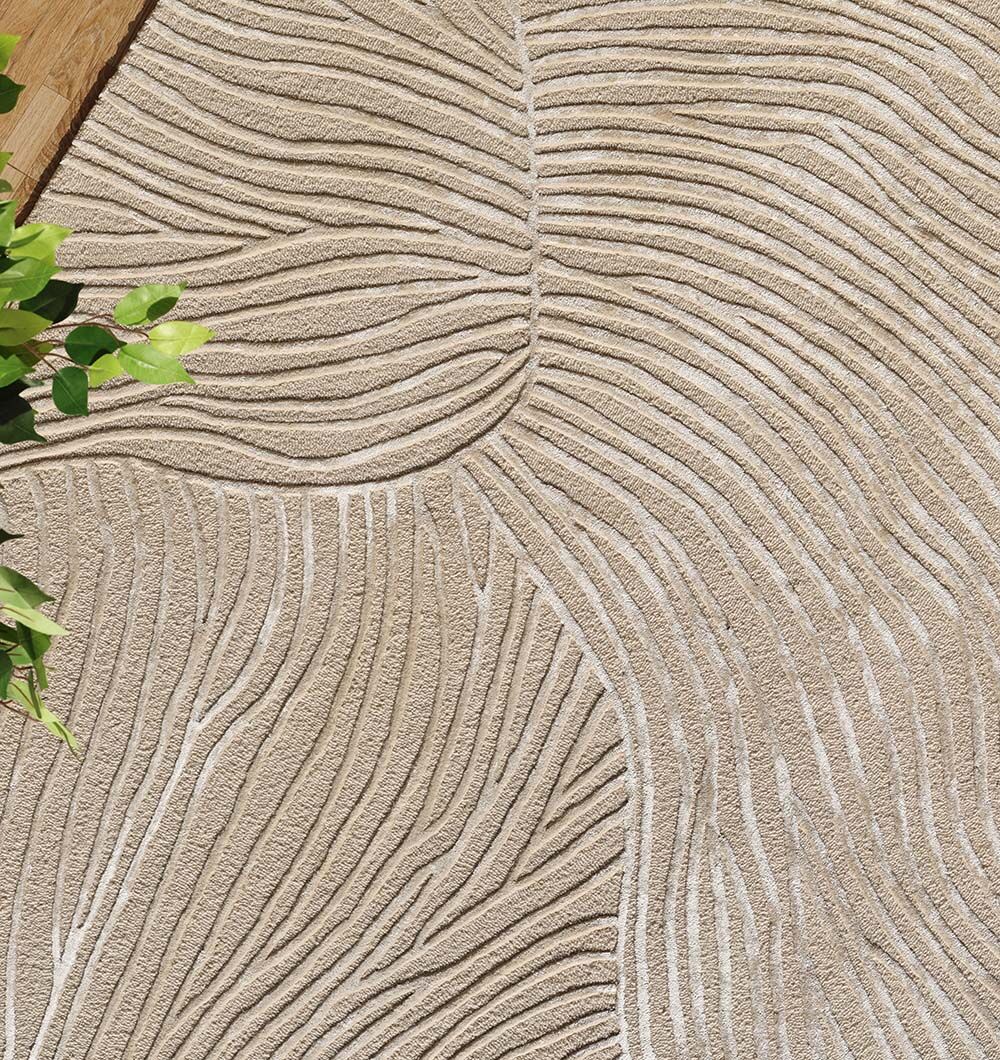 The RAMSHA HOME Natural White Handmade Area Rug (HTWV-143, 300x400 cm) features a textured surface with raised wavy lines in abstract plant patterns and soft lighting, with a small bunch of green leaves at the left edge.